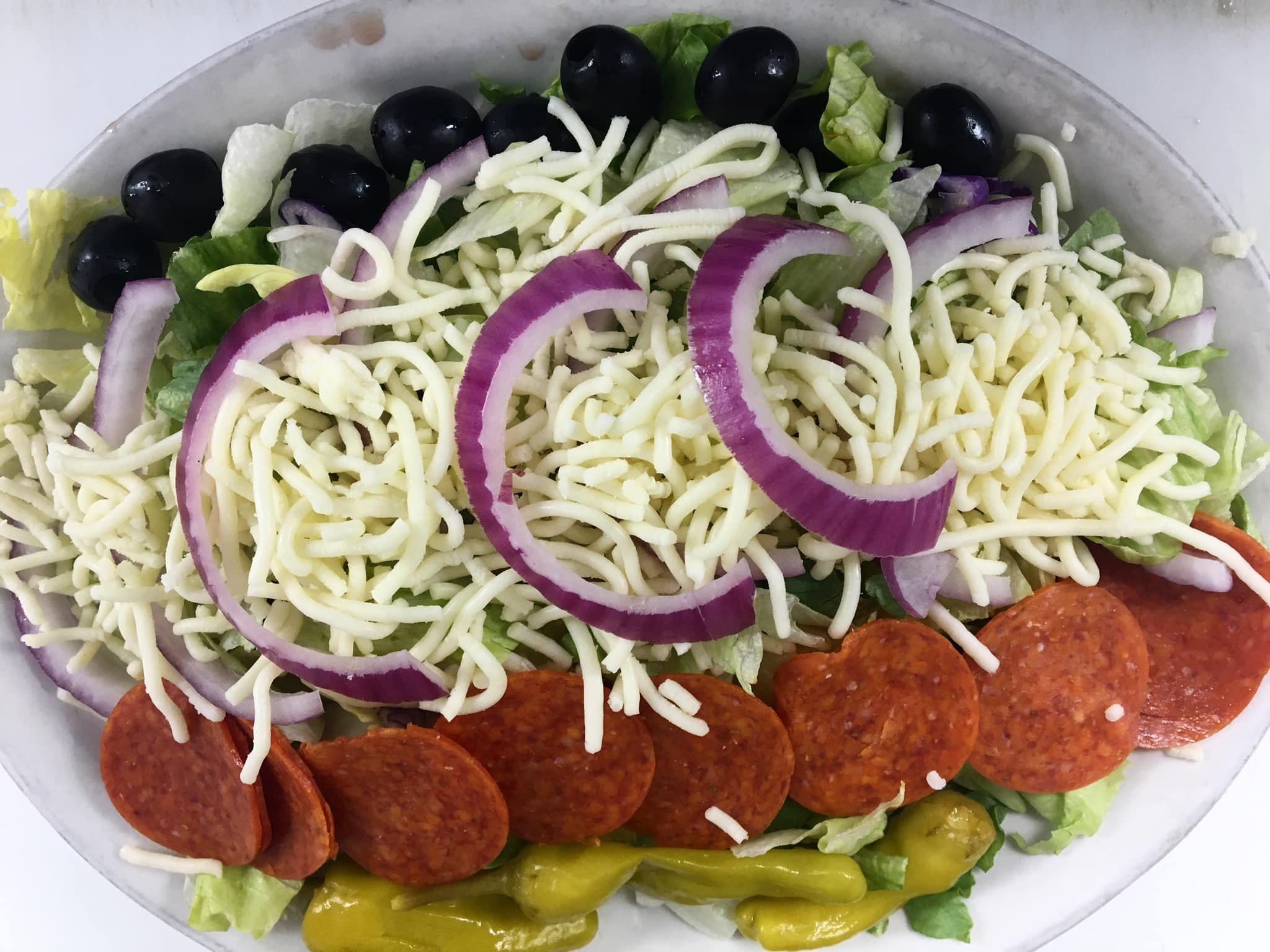 Order Italian Salad - Salad food online from Freds Pizza & Italian Restaurant store, Grand Rapids on bringmethat.com