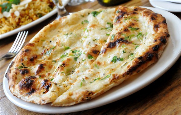 Order Garlic Naan(2) food online from Cosmos Indian Store & Cafe store, Lawrence on bringmethat.com
