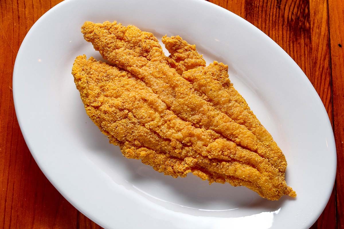 Order Catfish - 1 food online from Boudreaux's Cajun Kitchen store, Houston on bringmethat.com