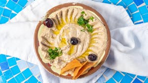 Order Hummus with Black Olive Paste food online from Marlena Mediterranean Deli store, Middletown on bringmethat.com