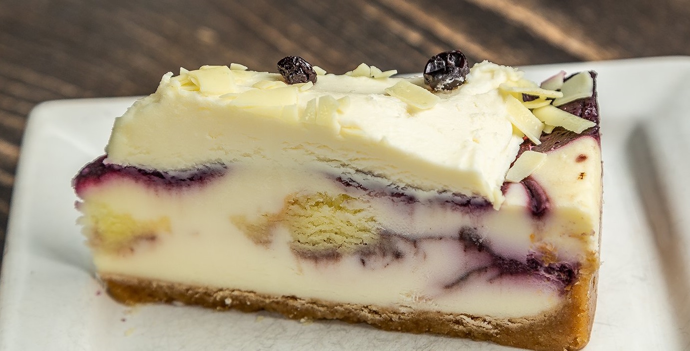 Order Blueberry Cobbler White Chocolate Cheesecake food online from MidiCi store, Orem on bringmethat.com