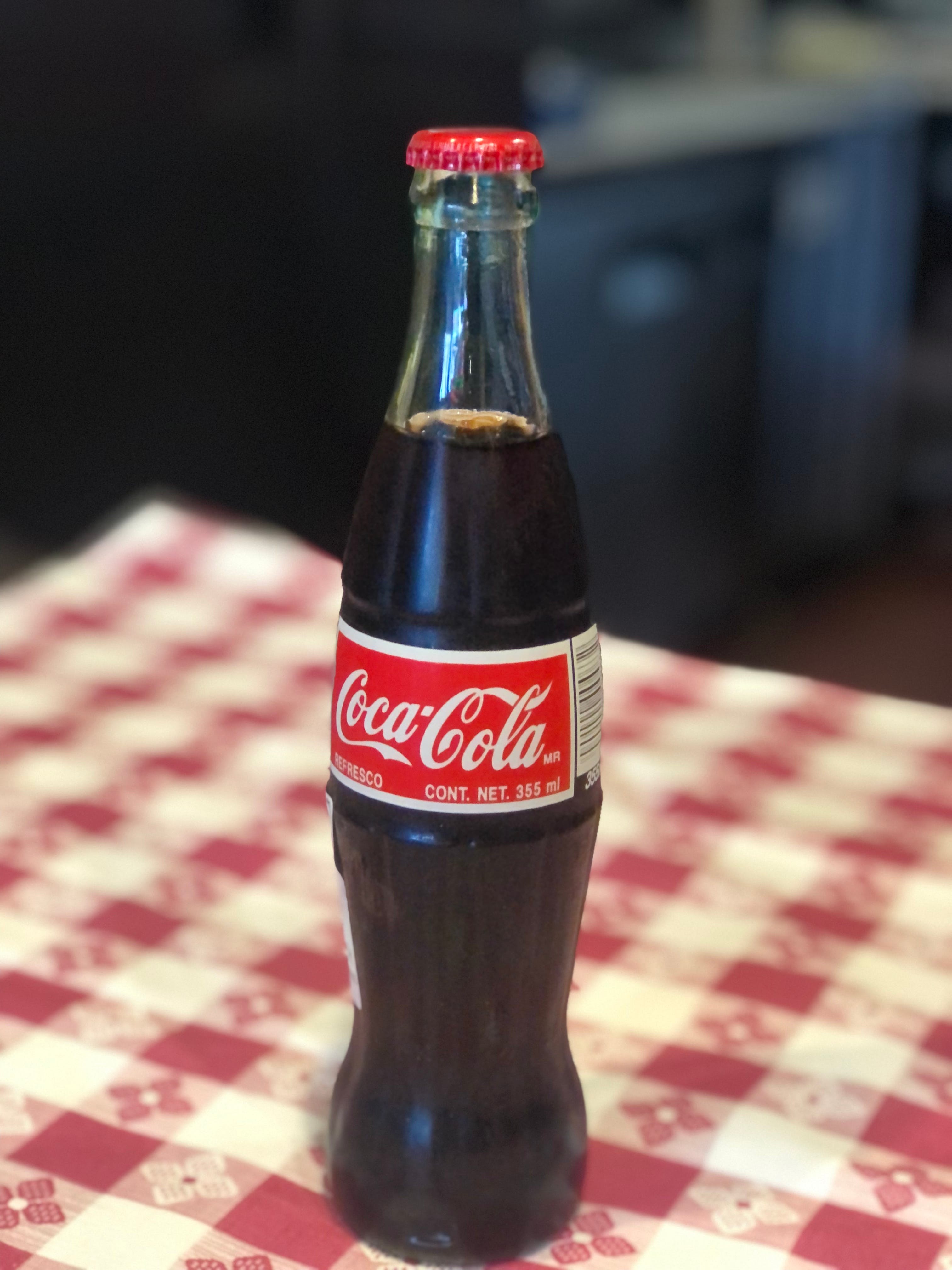 Order Mexican Coke - glass bottle food online from Pepe's NY Pizza - 11946 Ventura Blvd store, Studio City on bringmethat.com