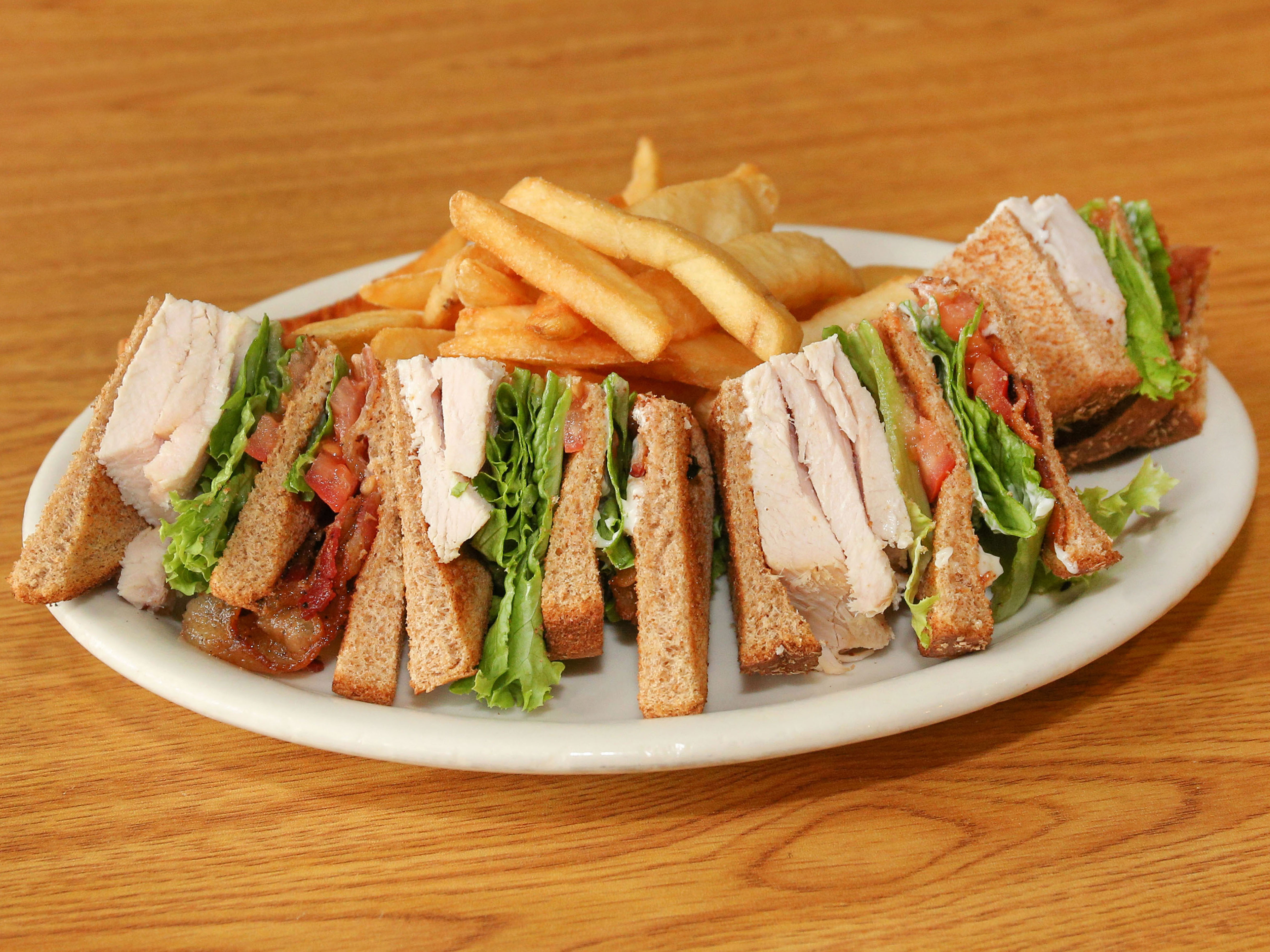 Order Turkey Club Sandwich food online from Peanuts Deluxe Cafe store, San Jose on bringmethat.com