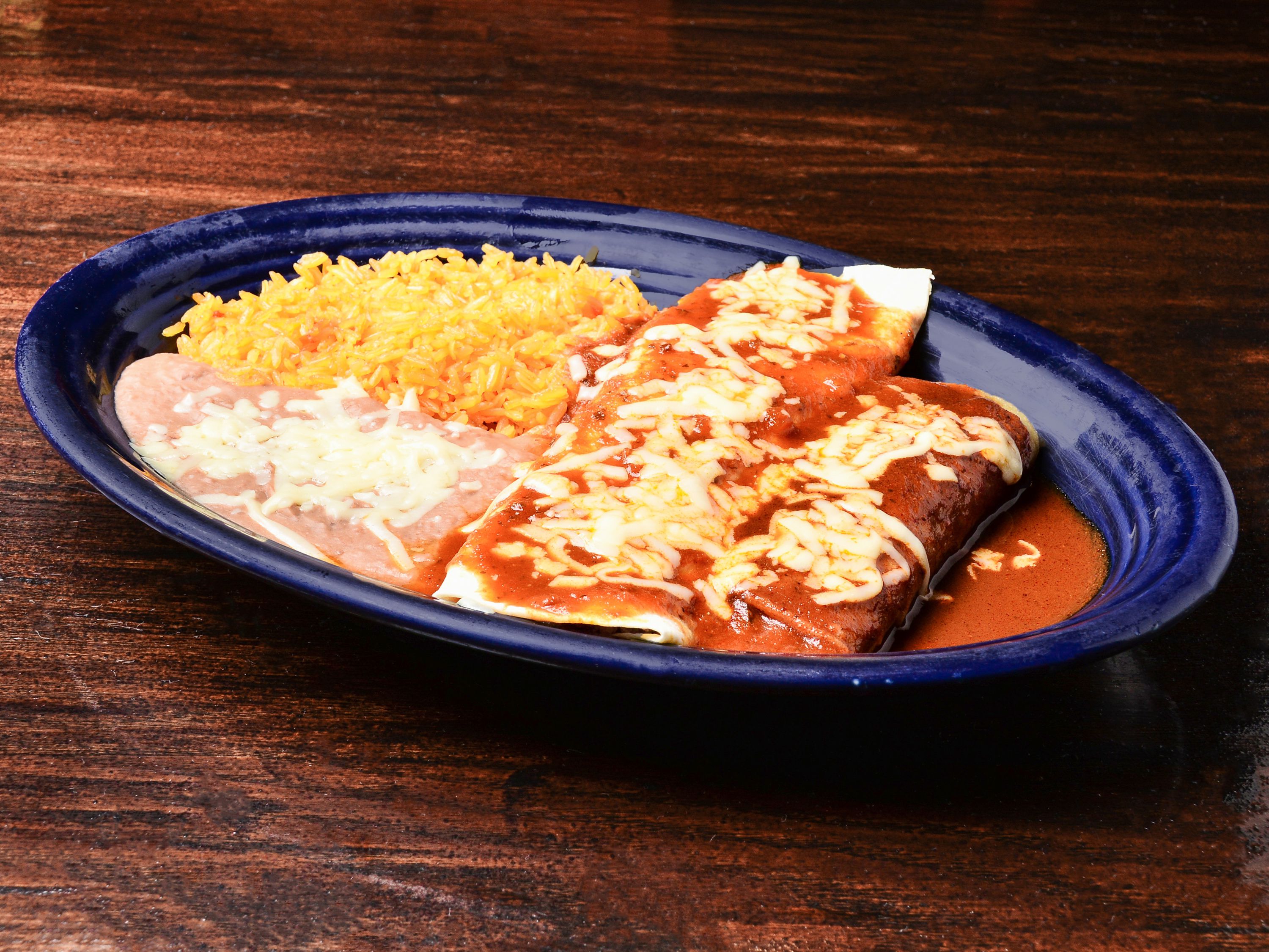 Order 18. Enchilada, Burrito, Mexican Rice and Refried Beans Combo food online from El Herradero Mexican Grill store, Piqua on bringmethat.com