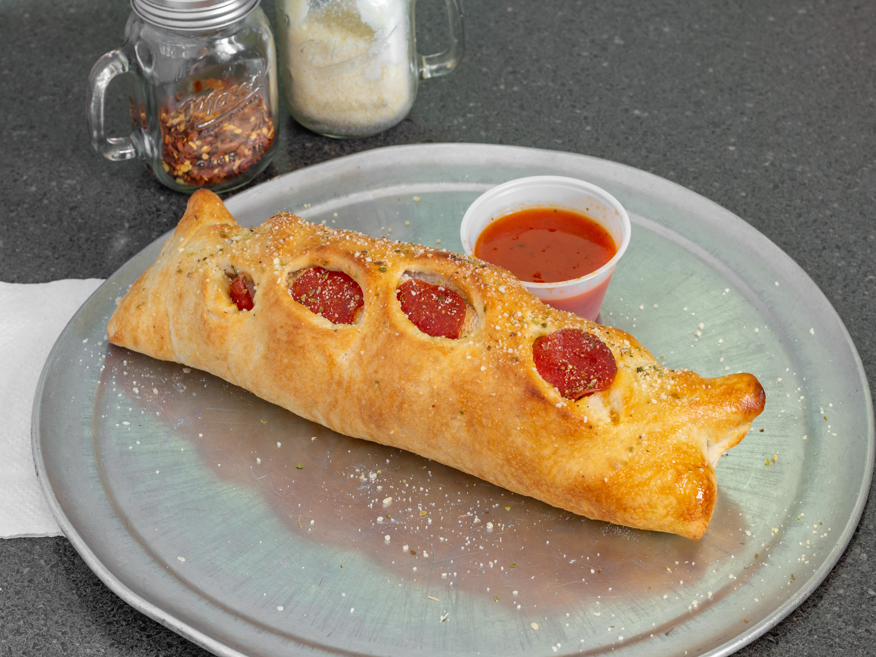Order Stromboli(Pepperoni, italian sausage, mushroom, onion, green peppers, black olives and mozzarella cheese. Served with marinara ) food online from Town center pizzeria store, Virginia Beach on bringmethat.com