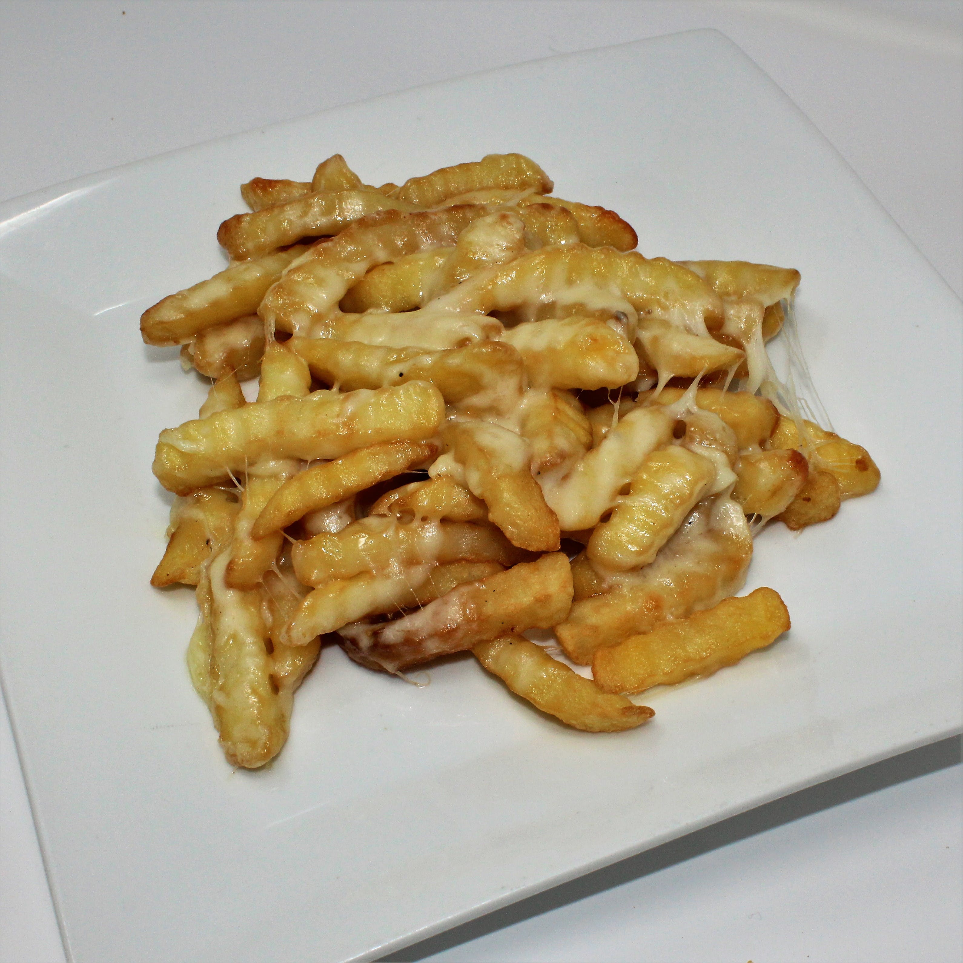 Order French Fries with Cheese - Appetizer food online from Mona Lisa Pizzeria Ristorante store, Bayonne on bringmethat.com