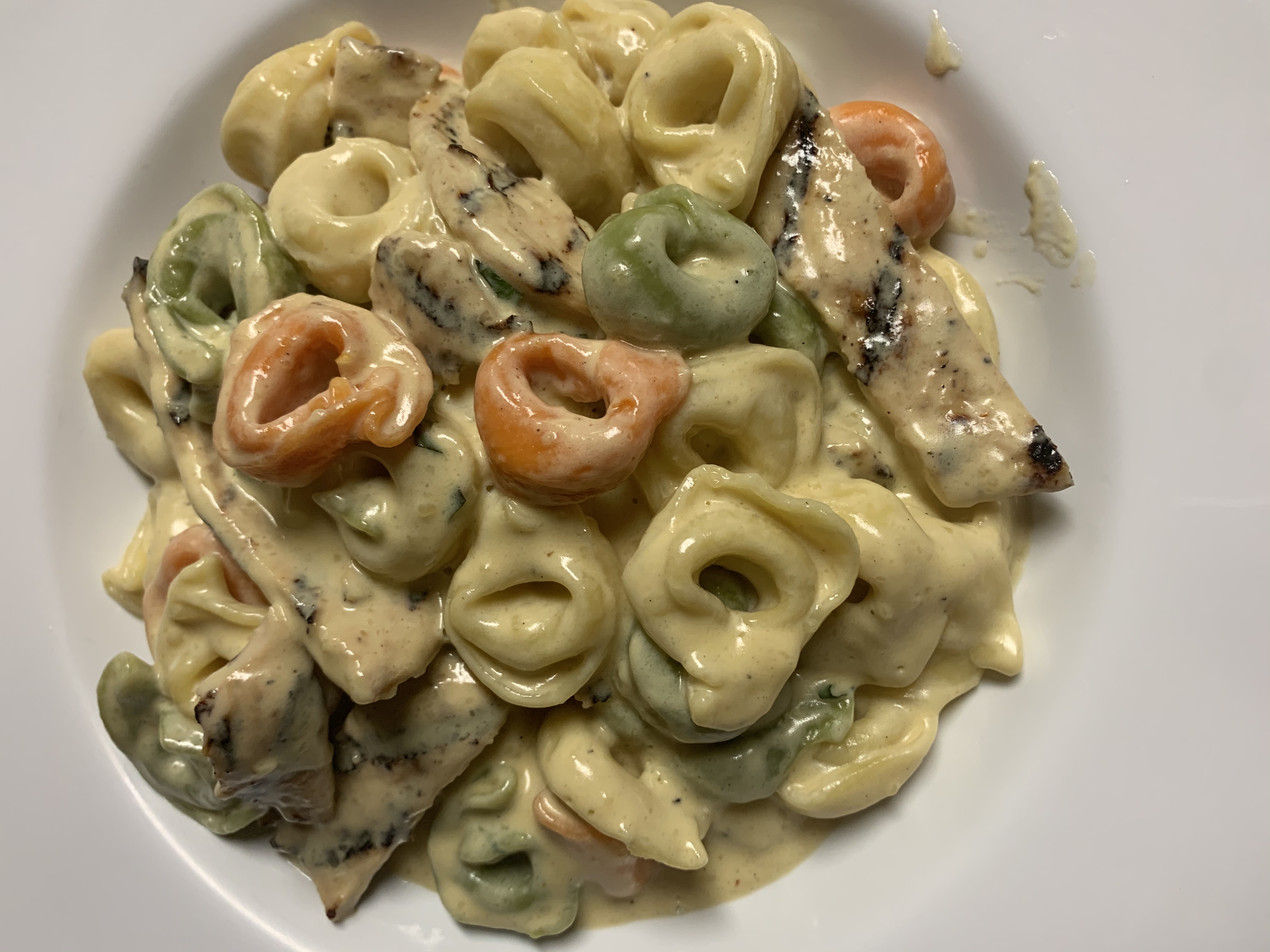 Order Tri Color Cheese Tortellini .w Alfredo sauace. Grilled Chicken food online from Taste of Italy Pizza store, Corona on bringmethat.com
