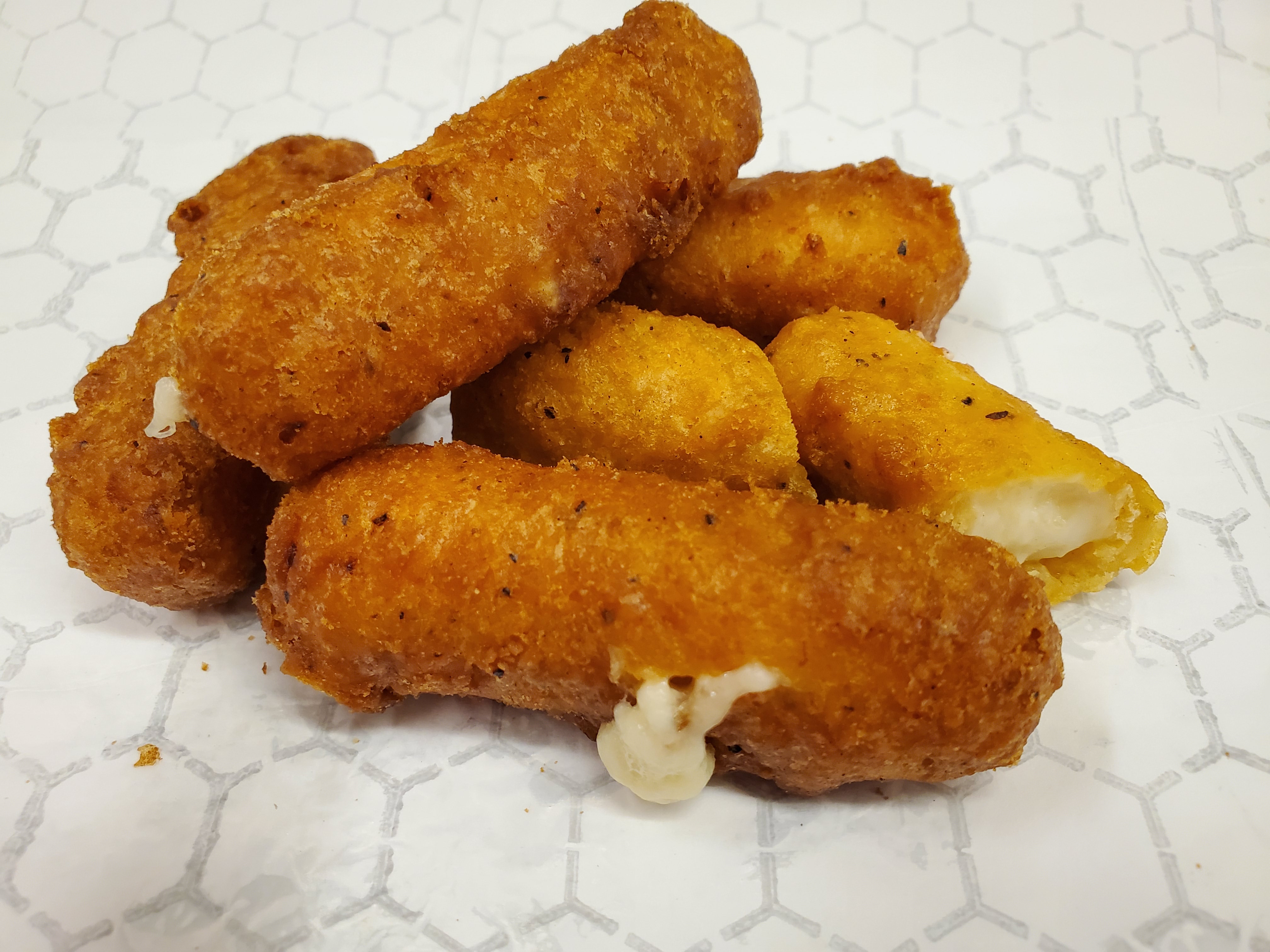 Order Mozzarella Sticks (5 breaded and fried mozzarella sticks with a crunchy, seasoned crust and a gooey and cheesy center) food online from Wing Depot store, Phoenix on bringmethat.com