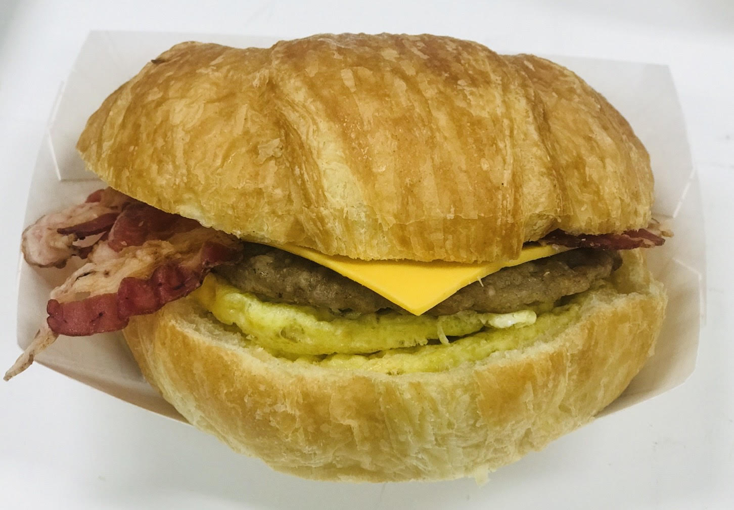 Order Sausage, Egg, and Cheese Croissant food online from Saginaw Donut Shop store, Saginaw on bringmethat.com
