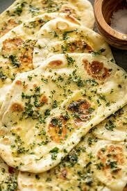 Order Fresh Minced Garlic Naan food online from Peacock Indian Cuisine store, Plano on bringmethat.com