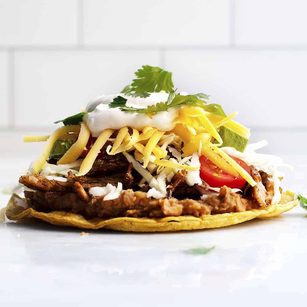 Order Carnitas Tostada food online from Sc Ranch Market store, San Clemente on bringmethat.com