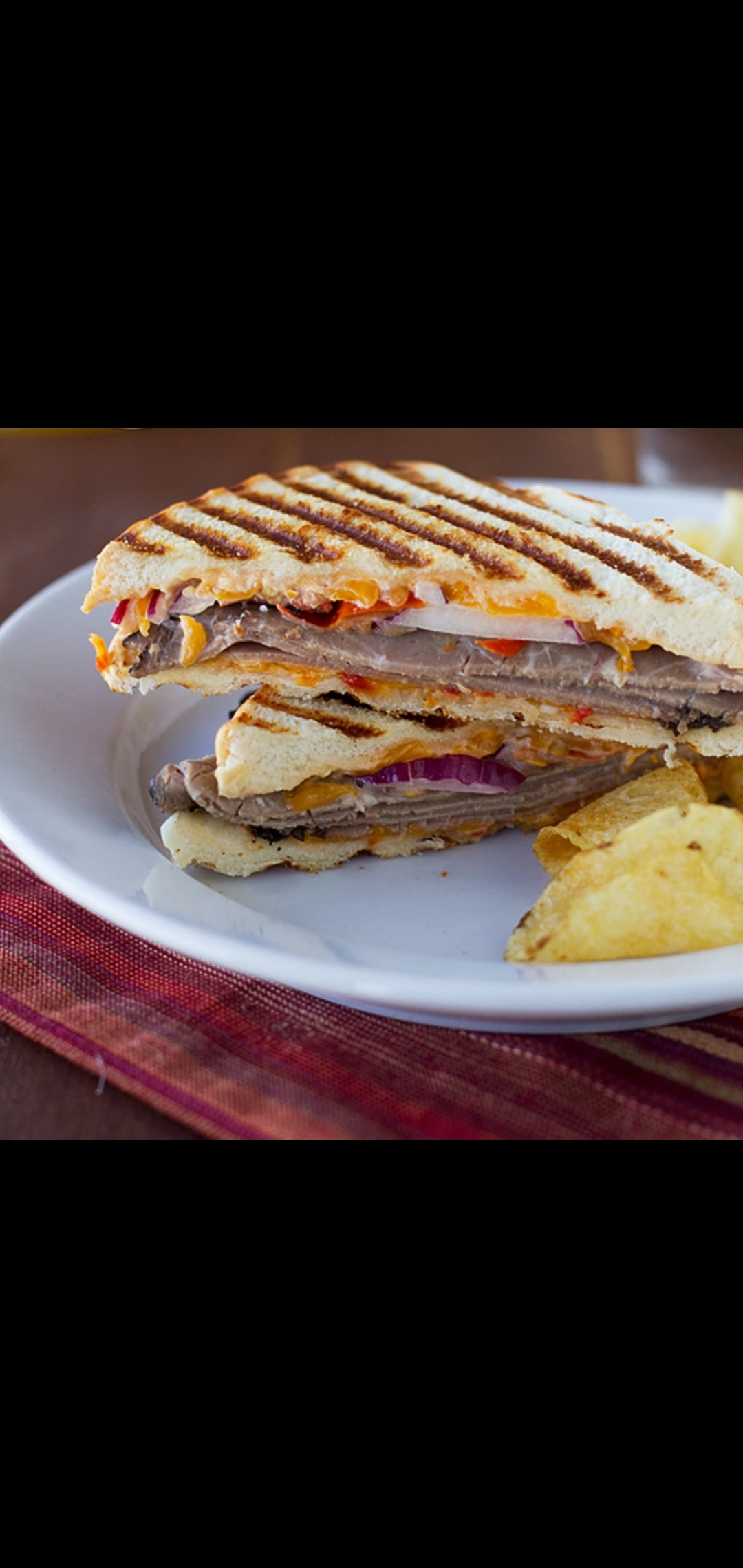 Order  Tex-Mex Panini (roast beef cheese lettuce tomatoes jalapeños onions chipotle mayonnaise) food online from American Gourmet Foods Deli store, New York on bringmethat.com