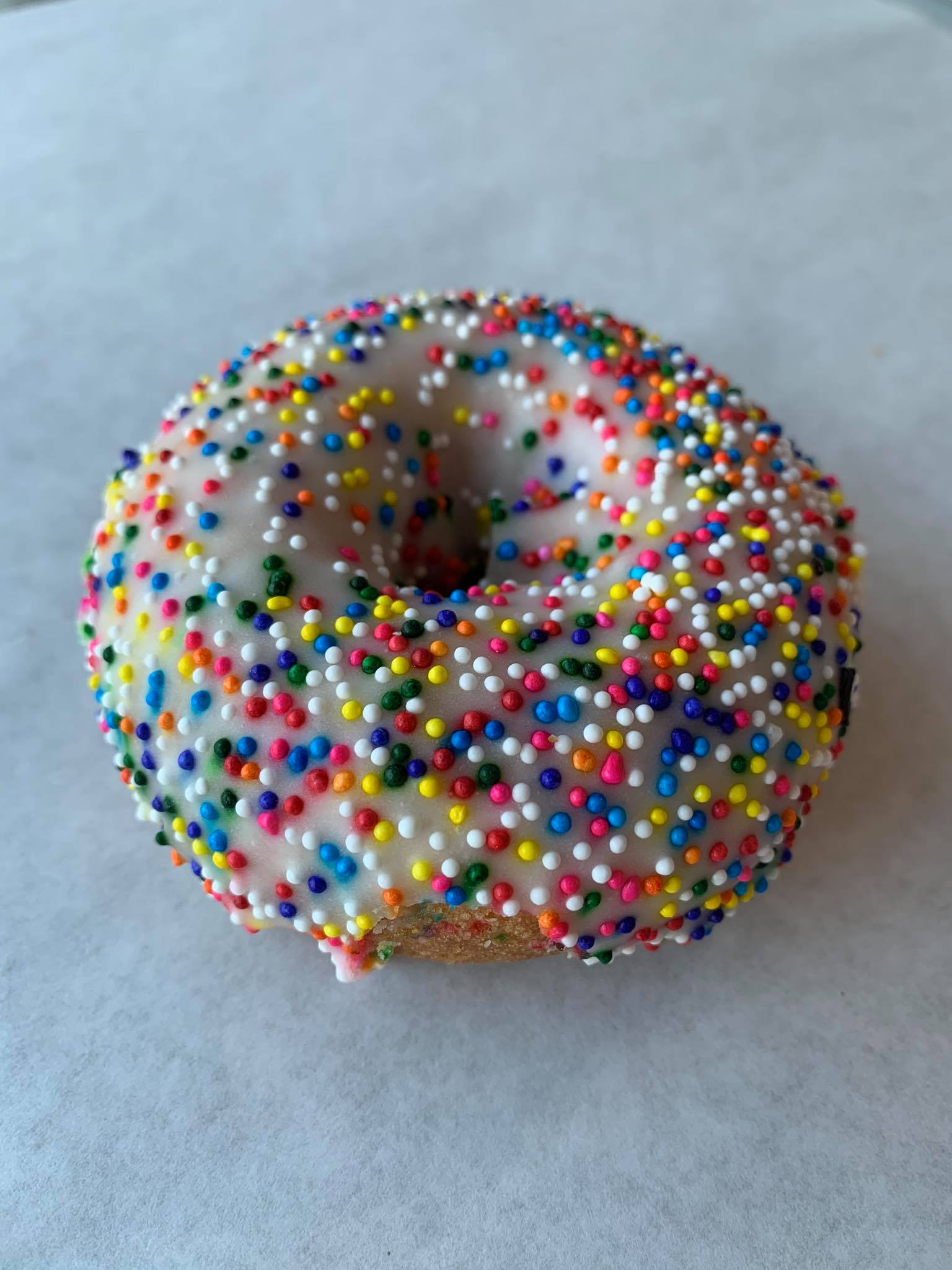 Order Rainbow sprinkle on white frosted cake food online from Honey Donuts store, Crowley on bringmethat.com