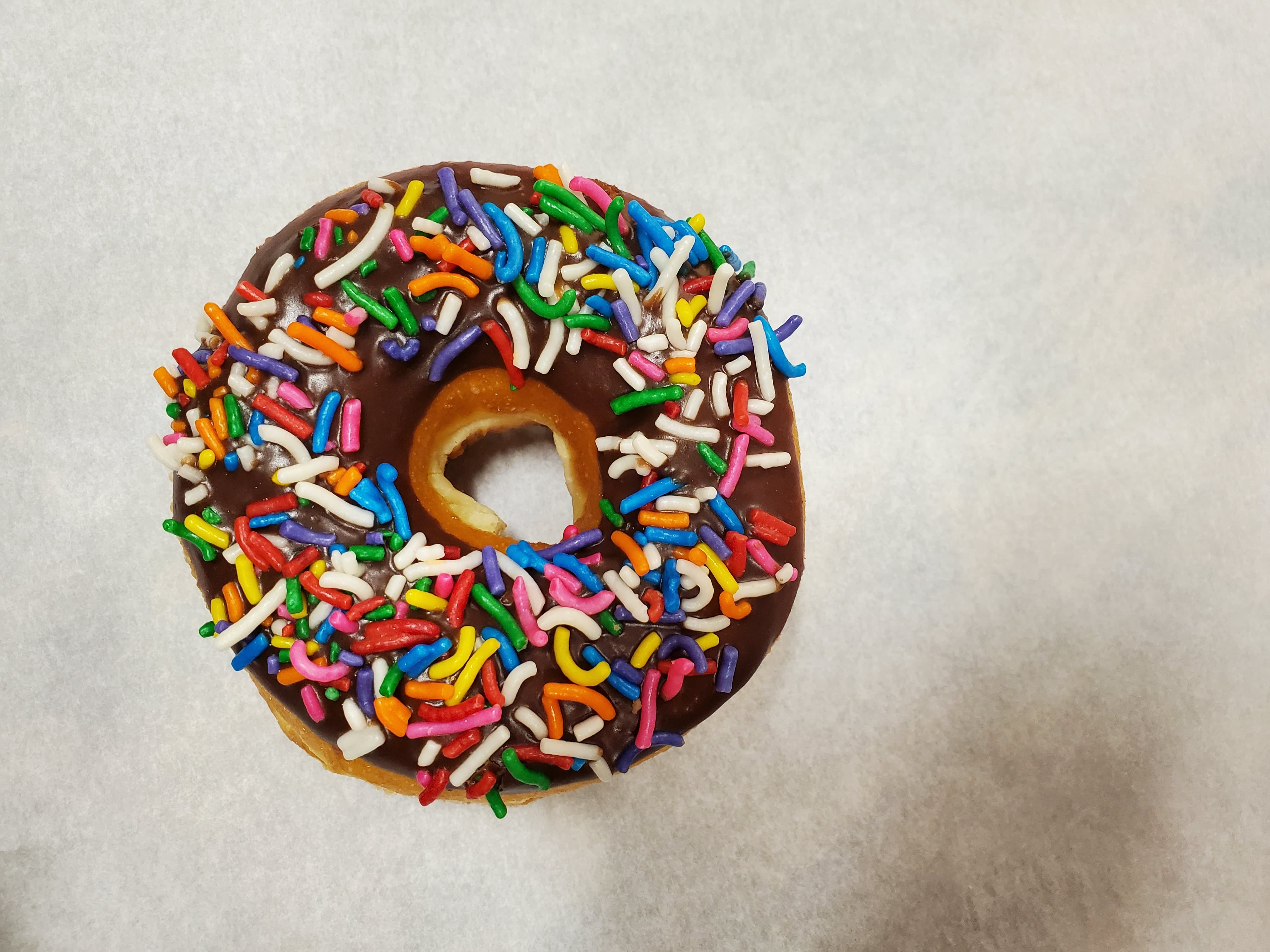 Order Color sprinkle on chocolate frosted donut food online from Honey Donuts store, Crowley on bringmethat.com