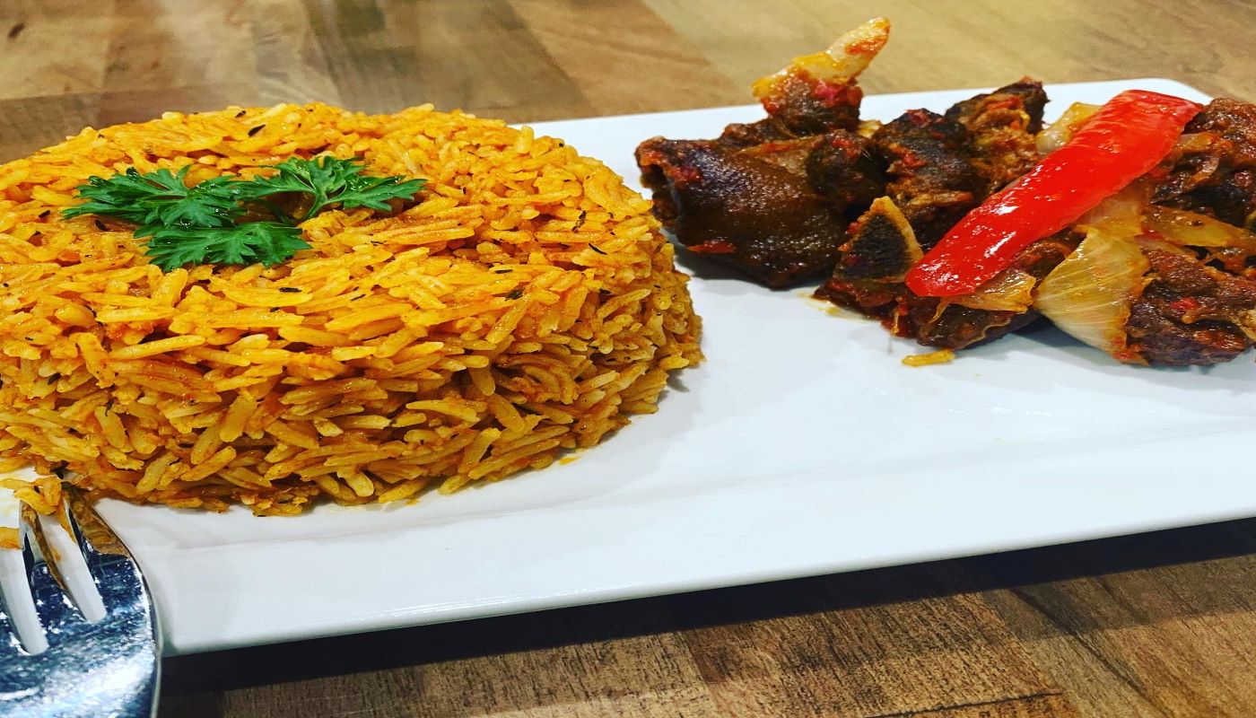 Order Jollof Rice + Peppered Goat Meat food online from Fusion Vibes Kitchen + Bar store, Richardson on bringmethat.com
