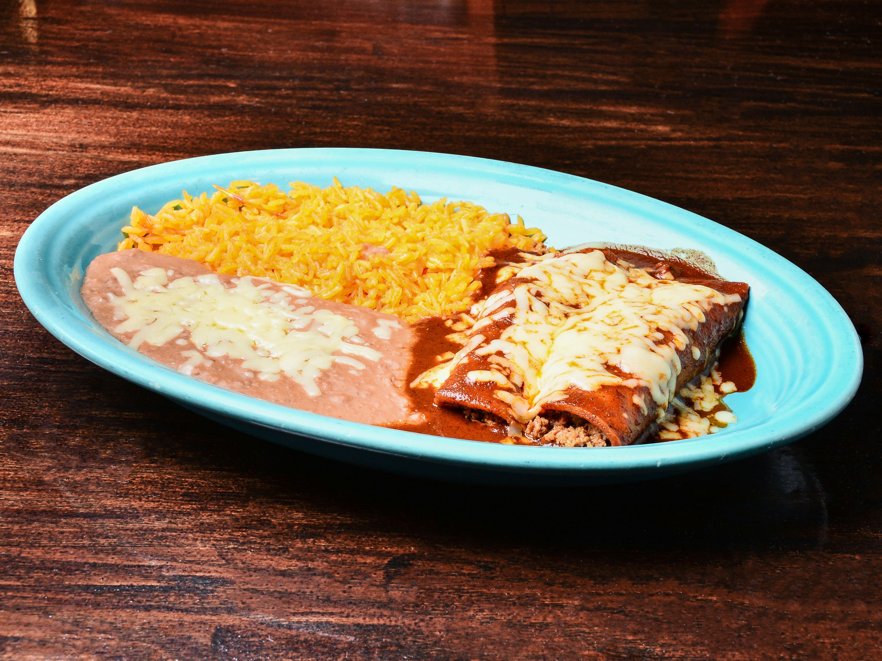 Order 12. 2 Enchiladas, Mexican Rice and Refried Beans Combo food online from El Herradero Mexican Grill store, Piqua on bringmethat.com