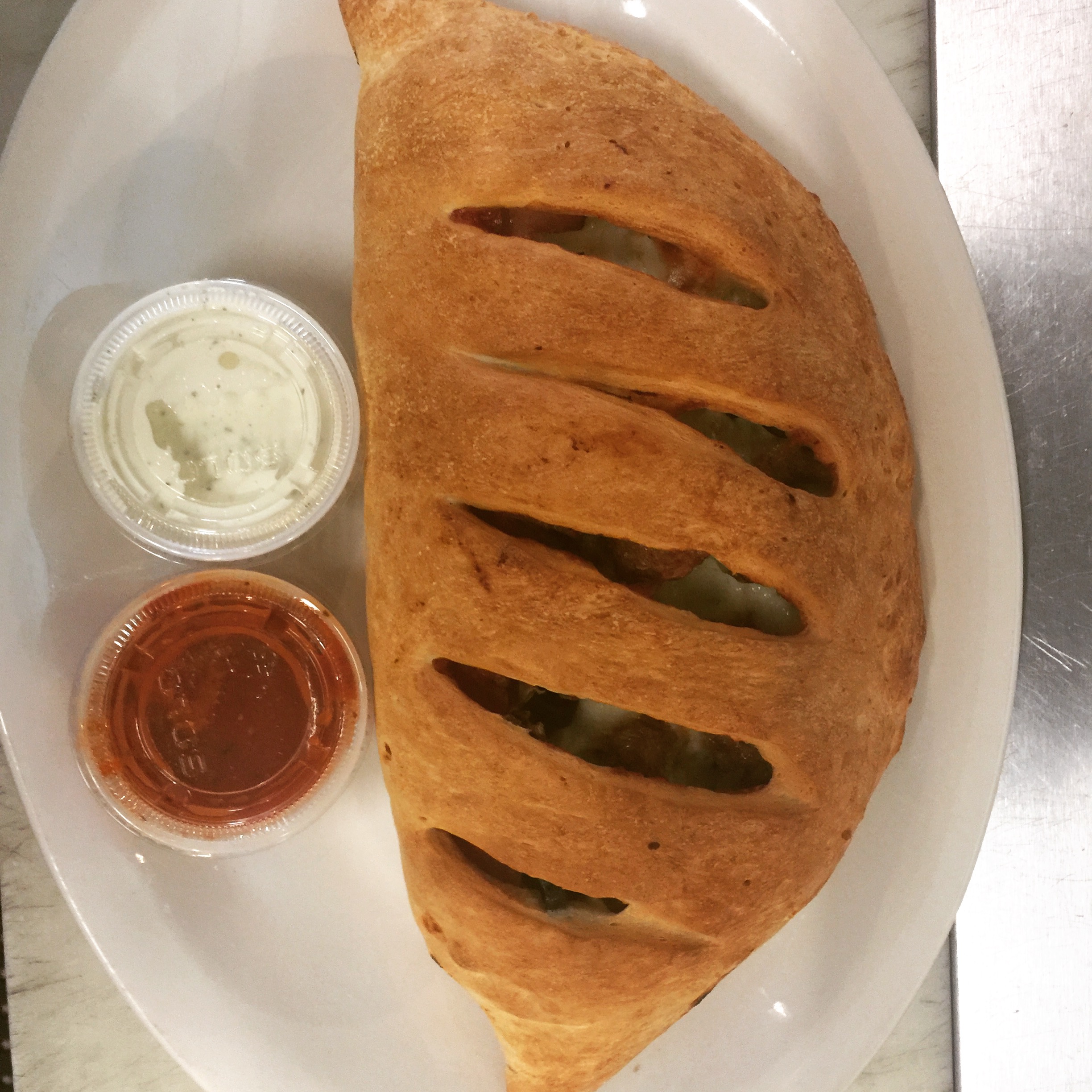 Order Classic Greek Calzone food online from Pizza Ragazzi store, Seattle on bringmethat.com