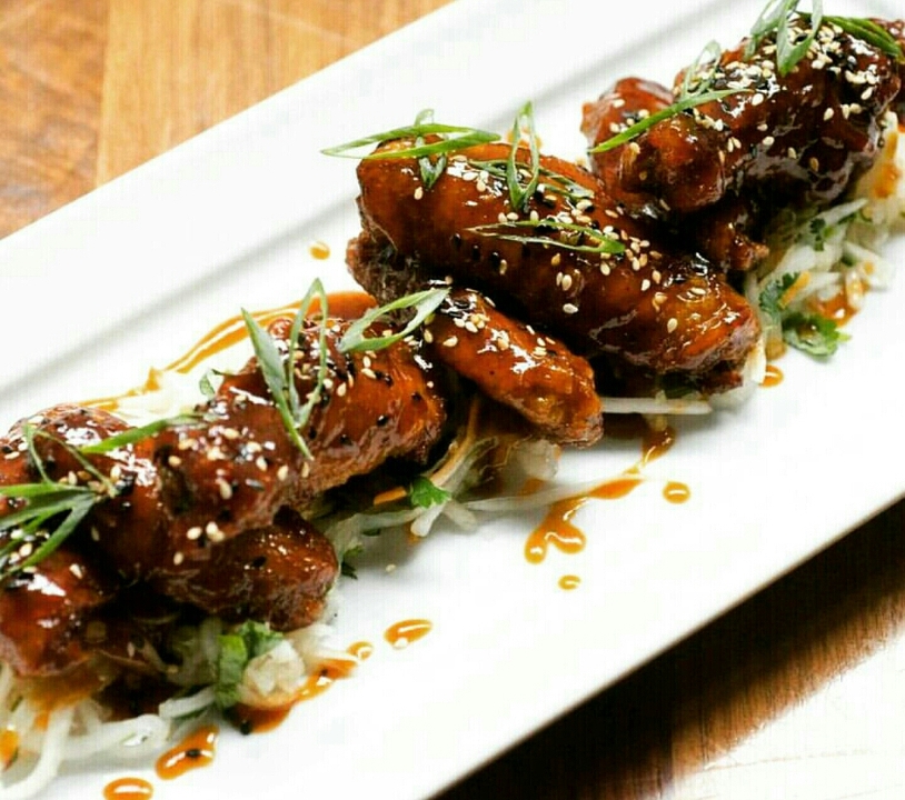 Order Sriracha Wings (12 small pieces) food online from Saigon Sisters store, Chicago on bringmethat.com