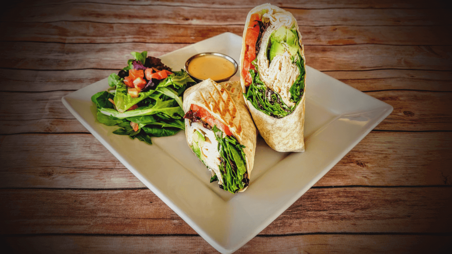 Order Turkey Avocado Wrap food online from Coupa Cafe store, Stanford on bringmethat.com