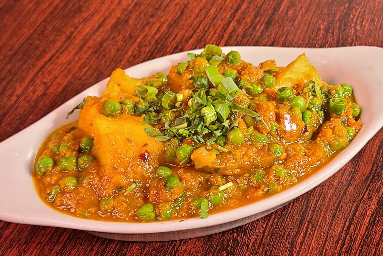 Order Aloo Matar food online from Om Indian Cuisine store, San Francisco on bringmethat.com