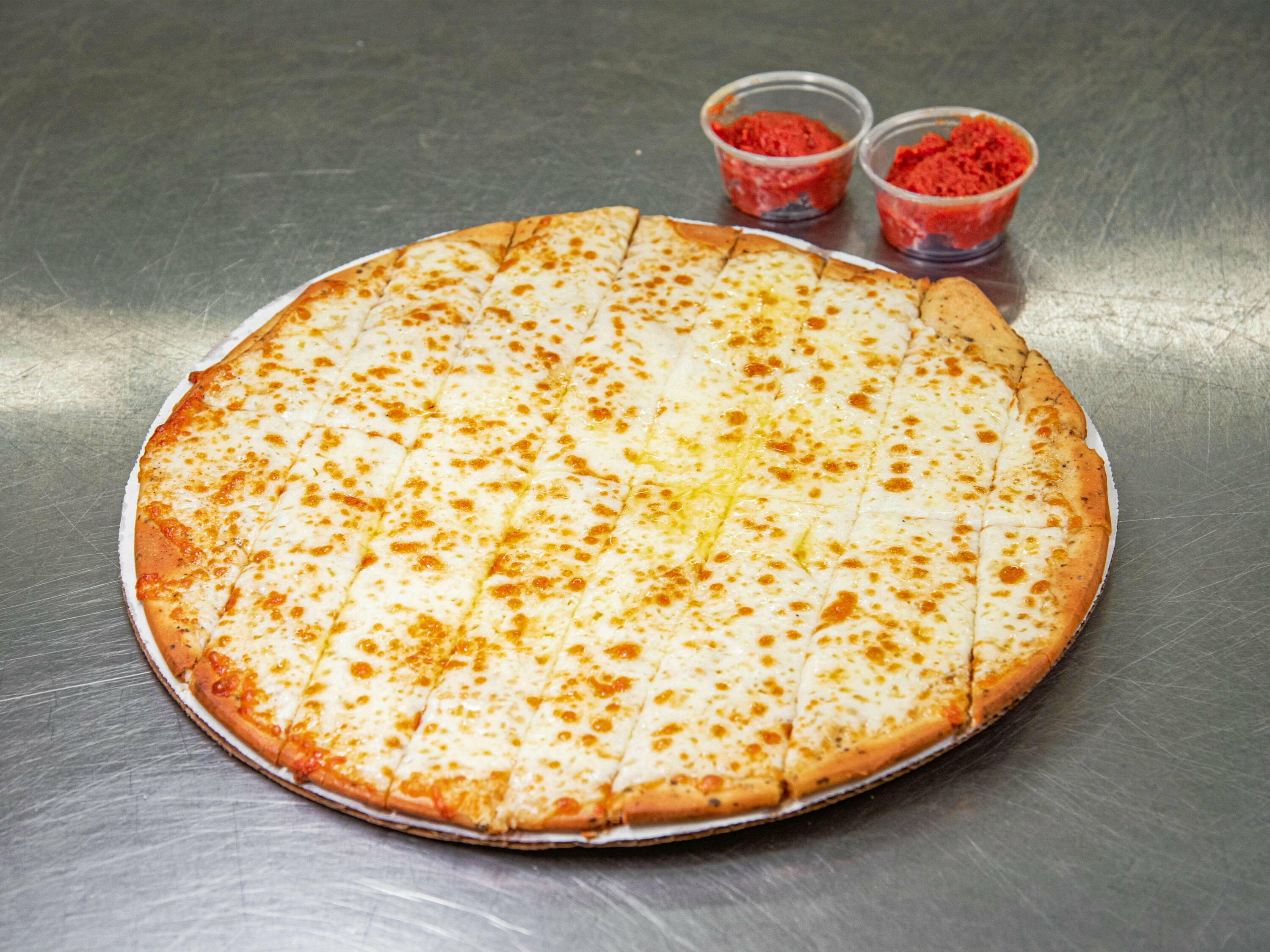 Order 16 Piece Cheesy Garlic Butter Breadsticks food online from The Ice Cream Shop store, Bellaire on bringmethat.com