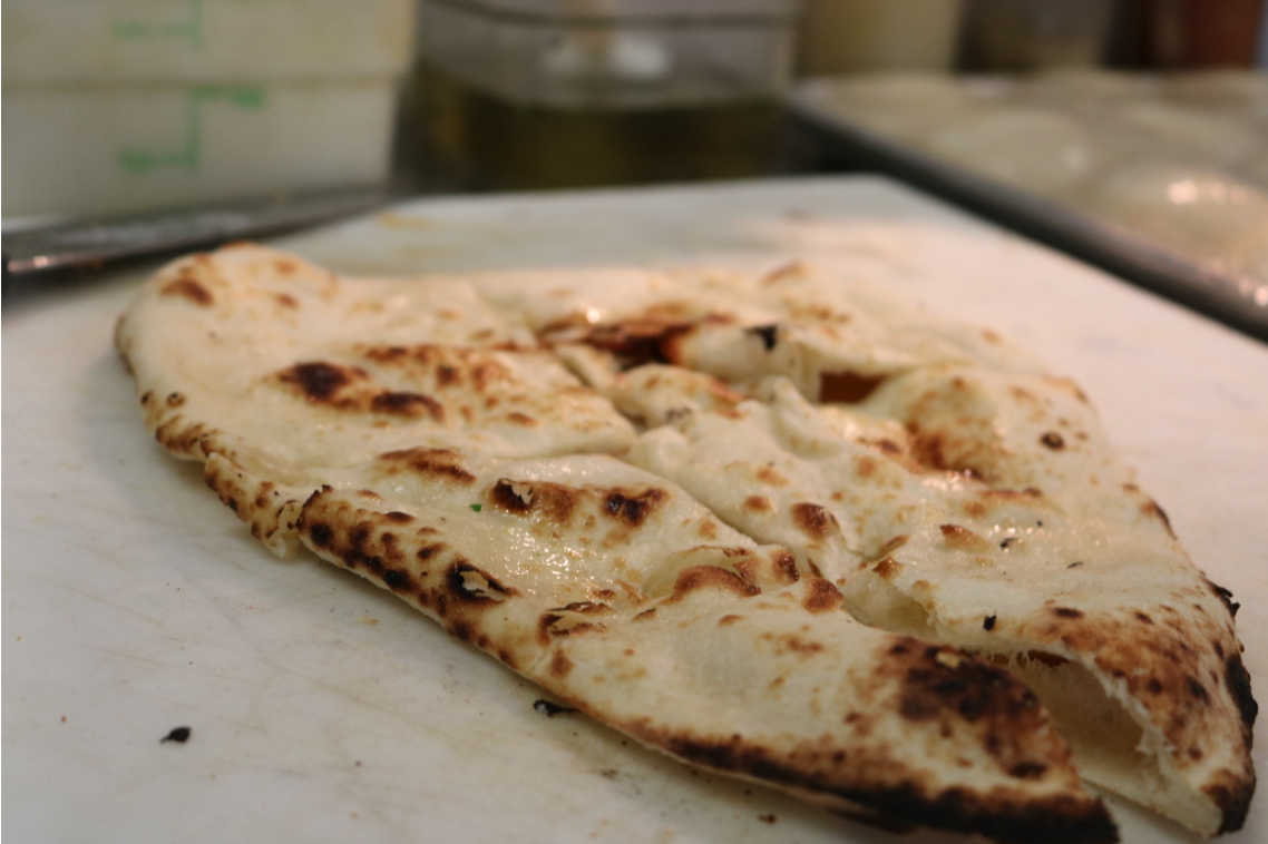 Order Buttered Naan food online from India Bistro store, Seattle on bringmethat.com