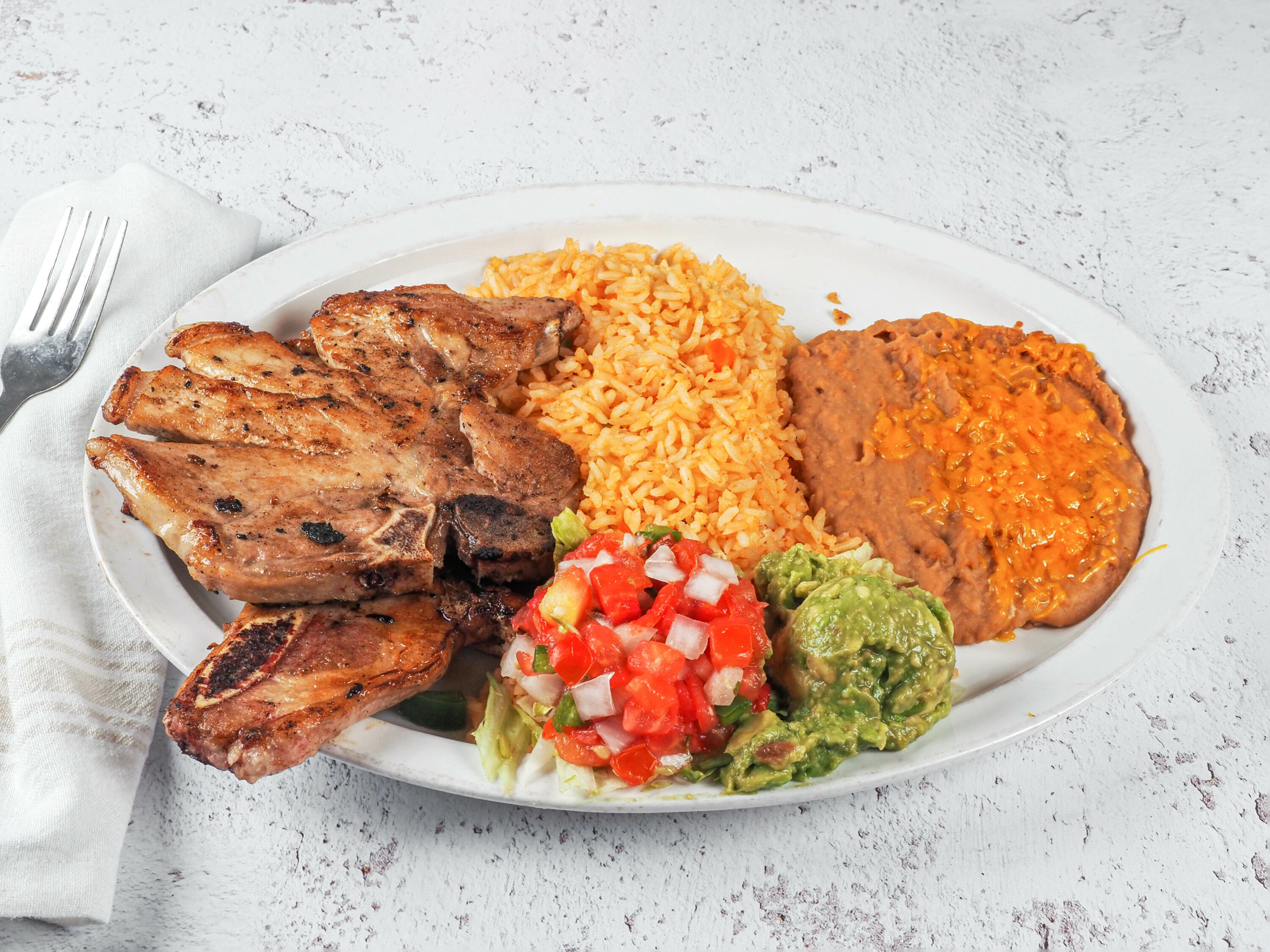 Order Pork Chops - Chuletas de Puerco food online from Zapata Mexican Grill store, Oklahoma City on bringmethat.com