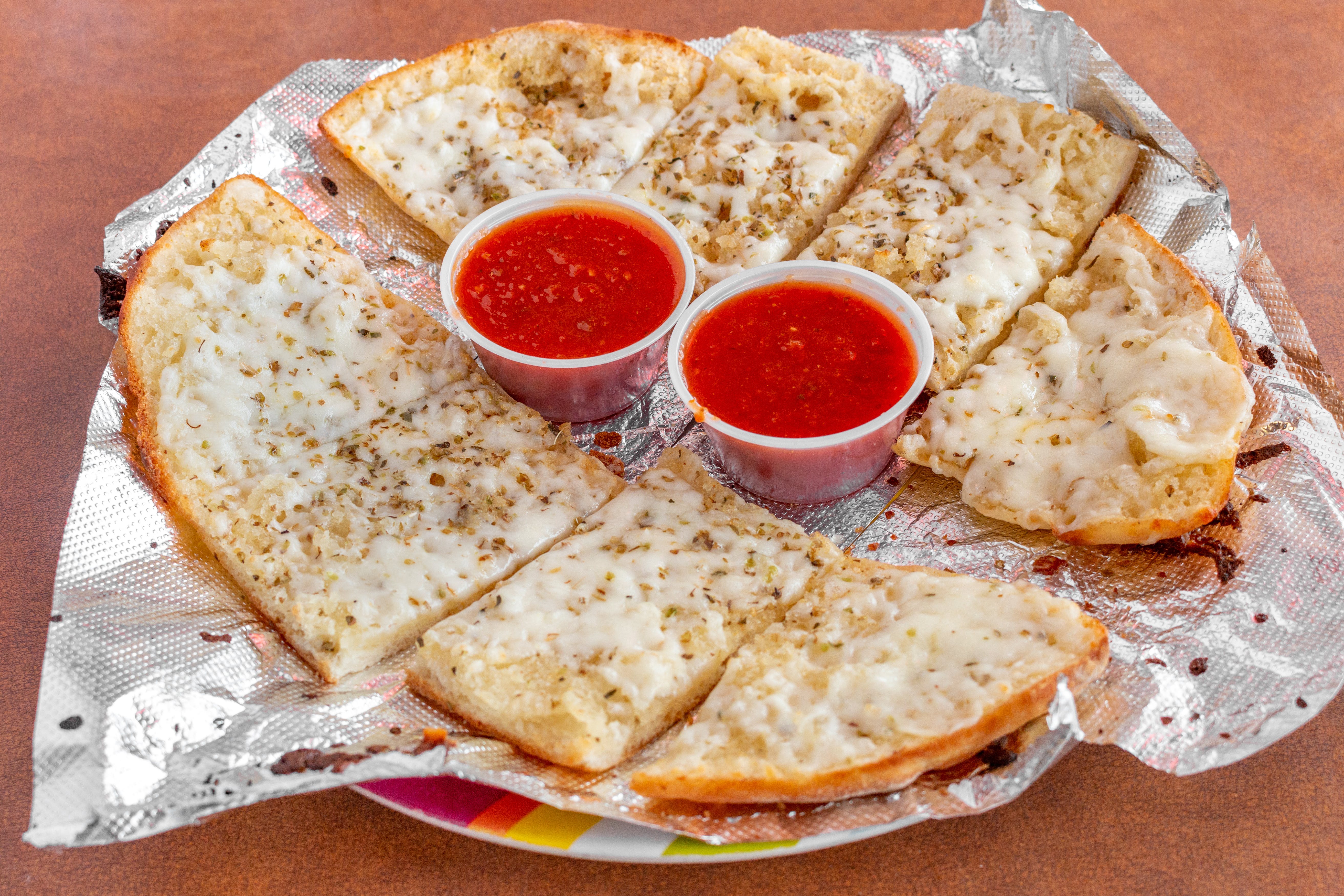Order Garlic Cheese Bread - Appetizer food online from Famous Pizza store, Denver on bringmethat.com