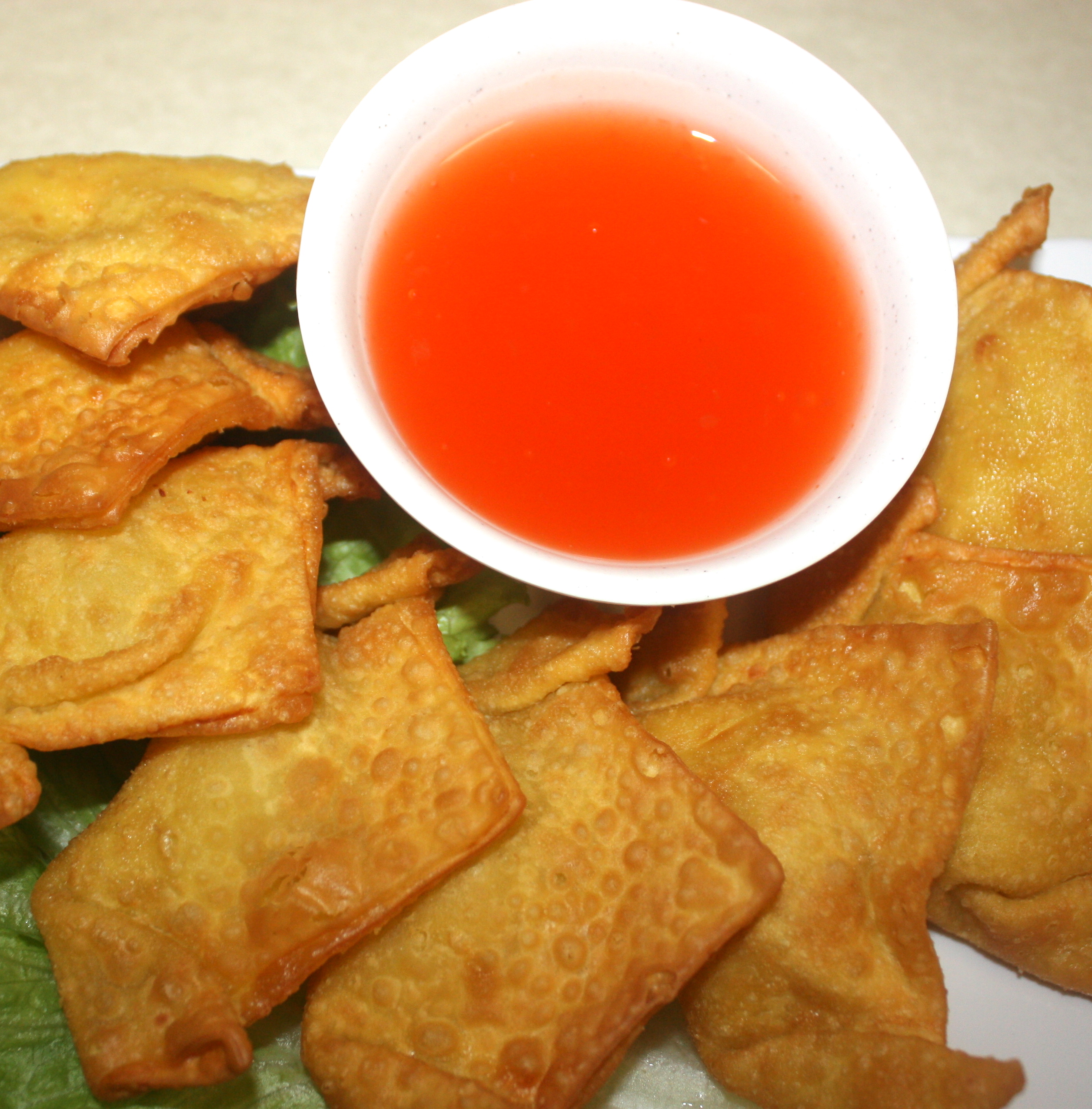 Order A6. Crab Rangoon food online from Nam's Noodle store, Madison on bringmethat.com