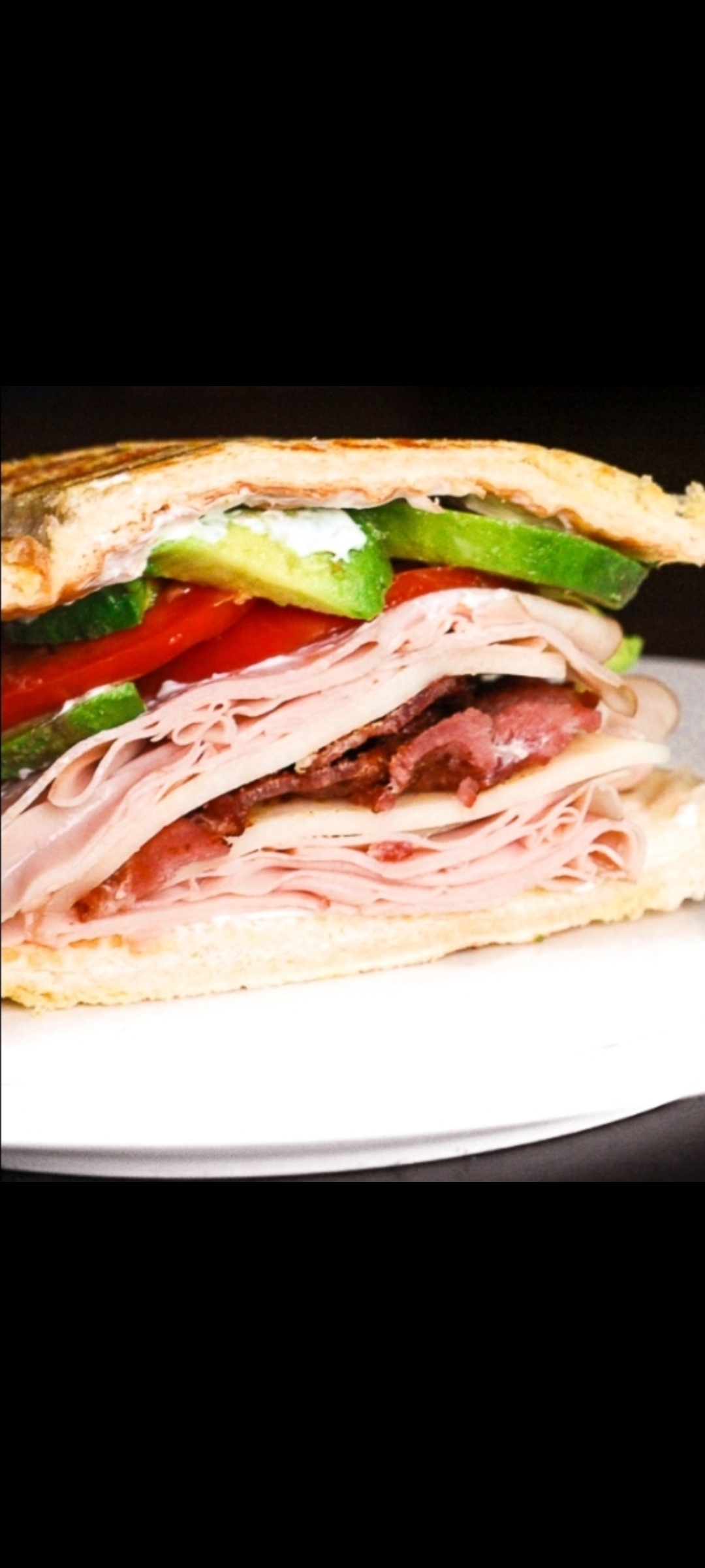Order Country Cob Panini (smoked turkey, avocado, bacon, mixed greens, tomatoes & parmesan cheese) food online from American Gourmet Foods Deli store, New York on bringmethat.com