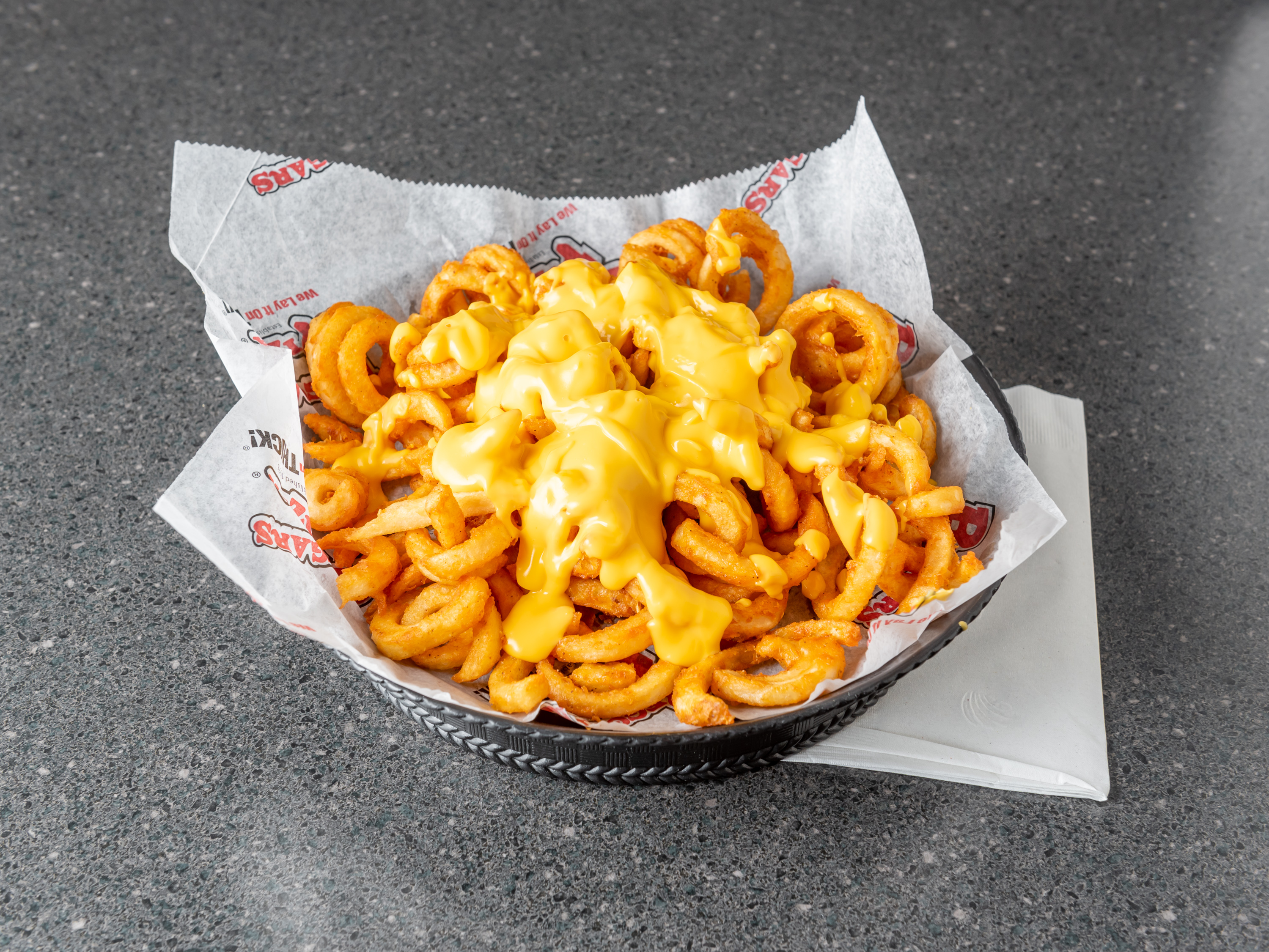 Order Curly Cheese Fries food online from Beggars Pizza store, Orland Park on bringmethat.com
