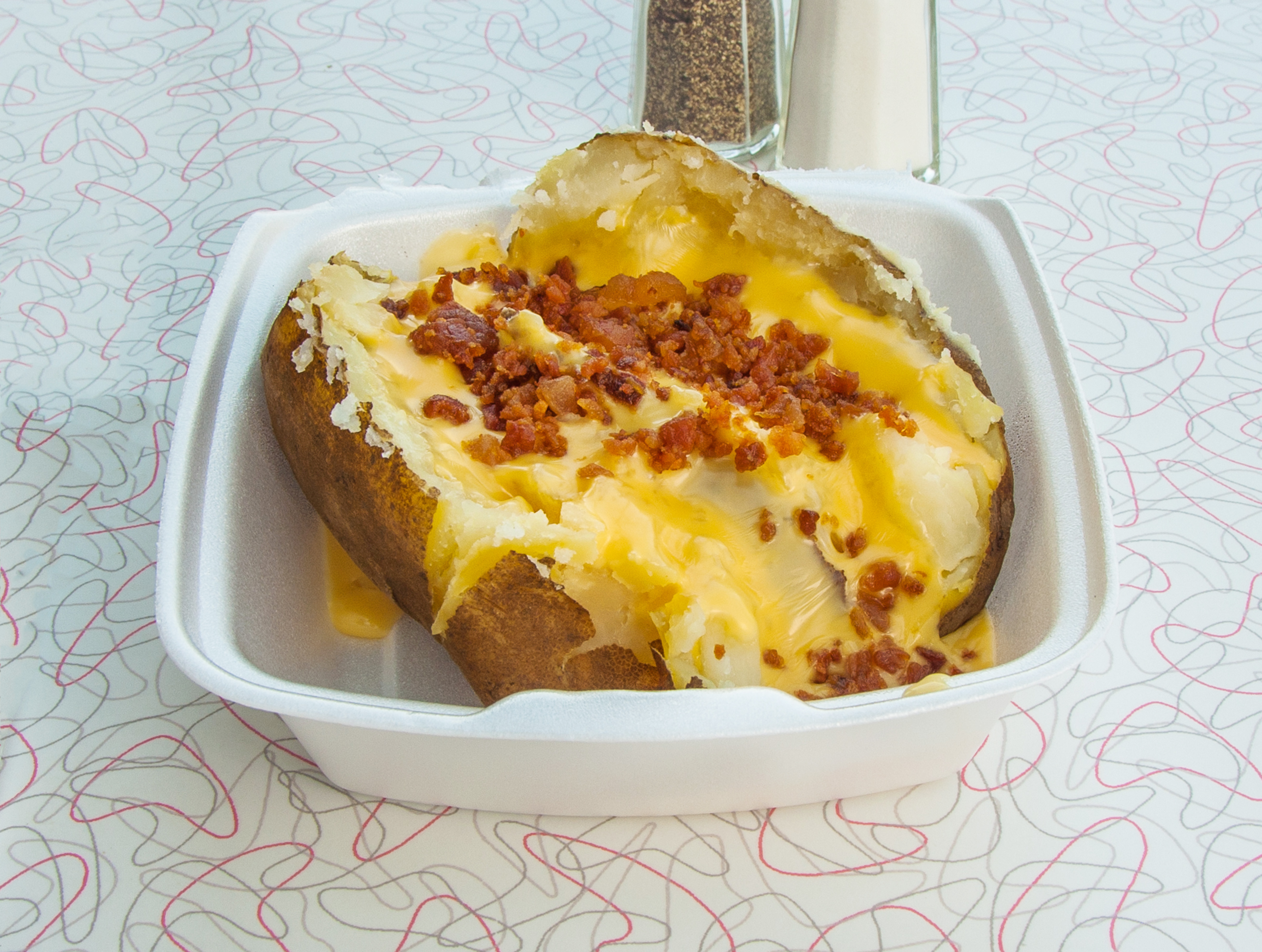 Order Bacon and Cheese Baked Potato food online from Rax store, Joliet on bringmethat.com