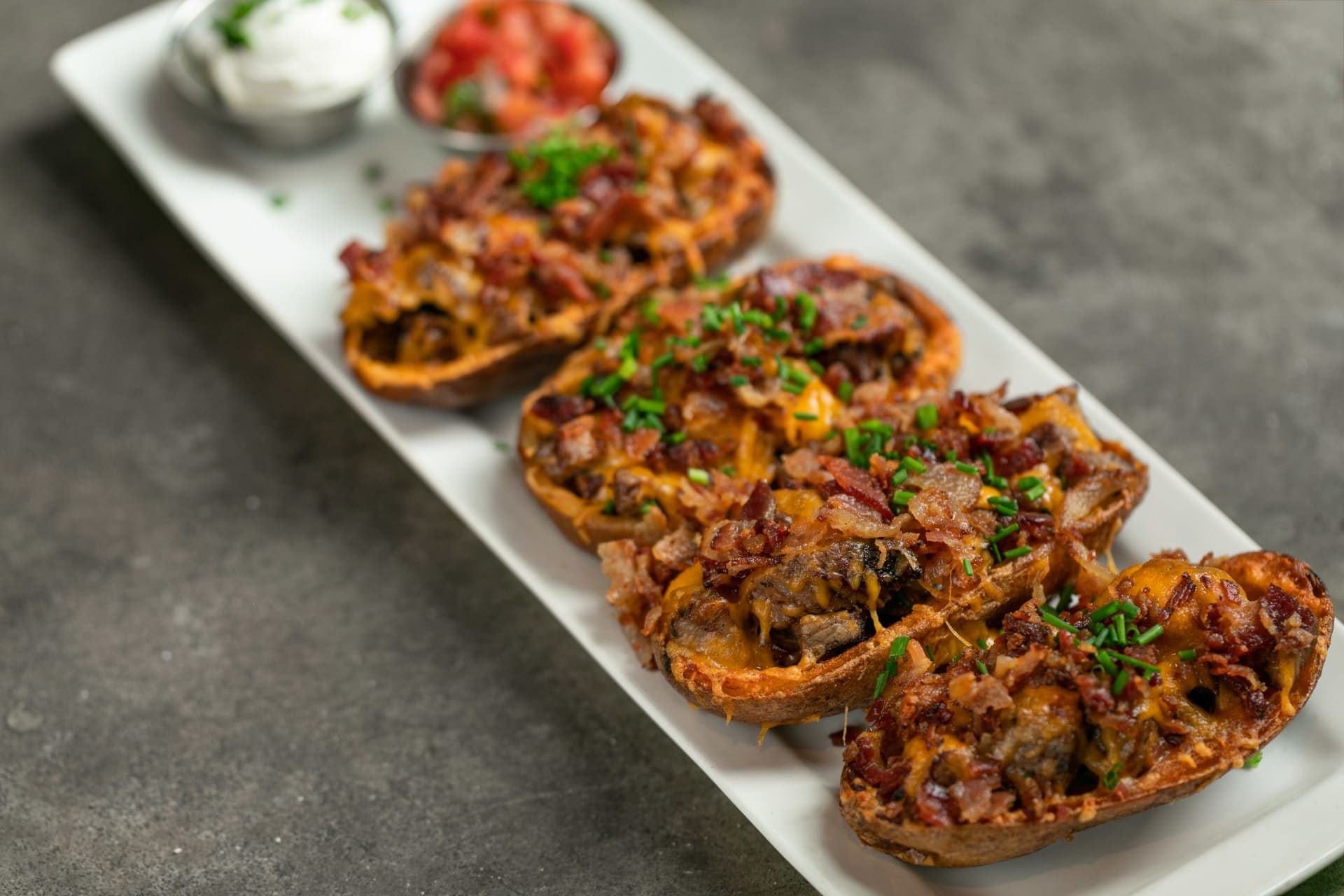 Order La Reina Lager Tri-Tip Potato Skins food online from Rincon Brewery store, Ventura on bringmethat.com