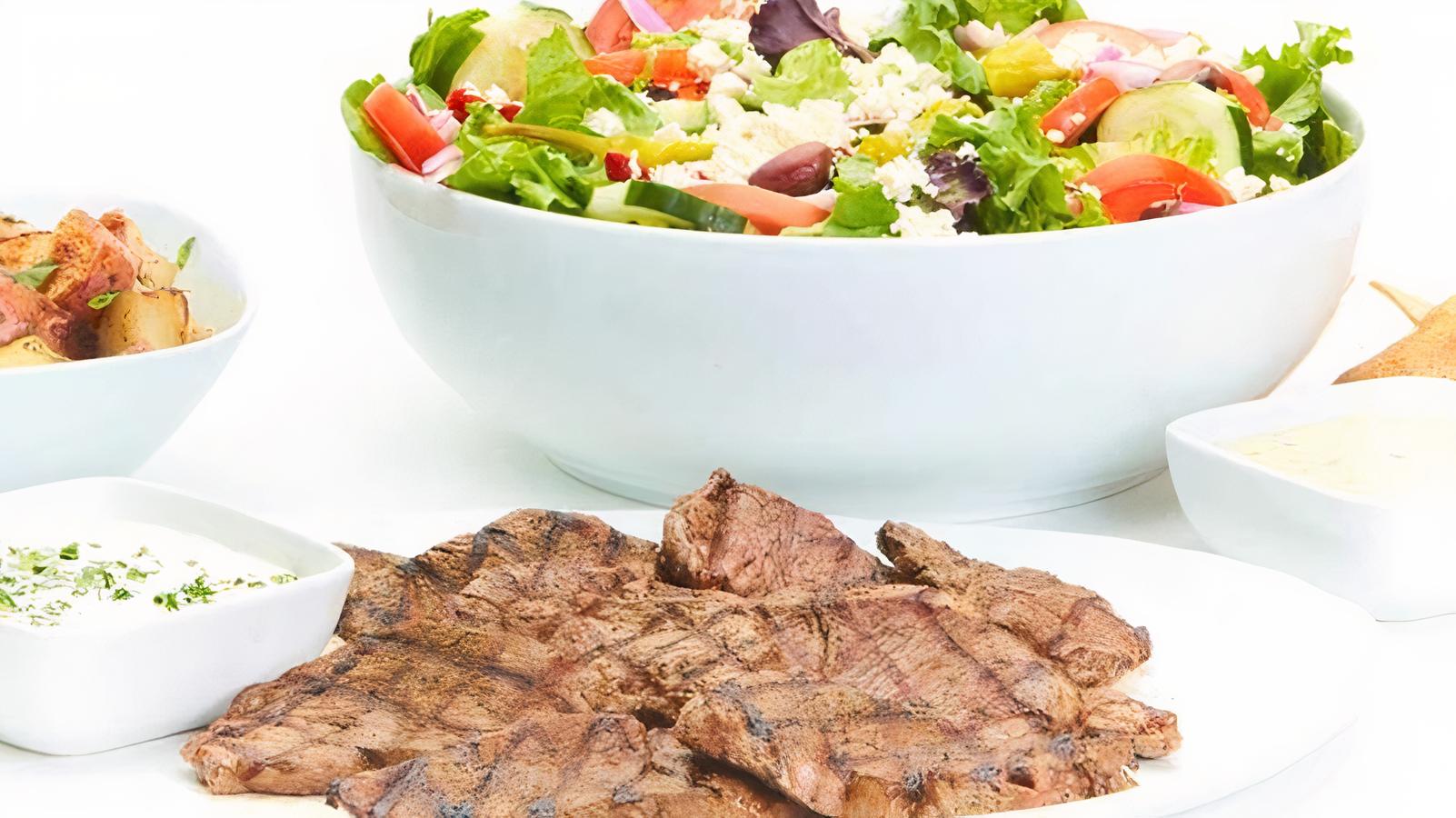 Order Chargrilled Lamb Family Feast for 4 food online from Taziki Mediterranean Cafe store, Atlanta on bringmethat.com