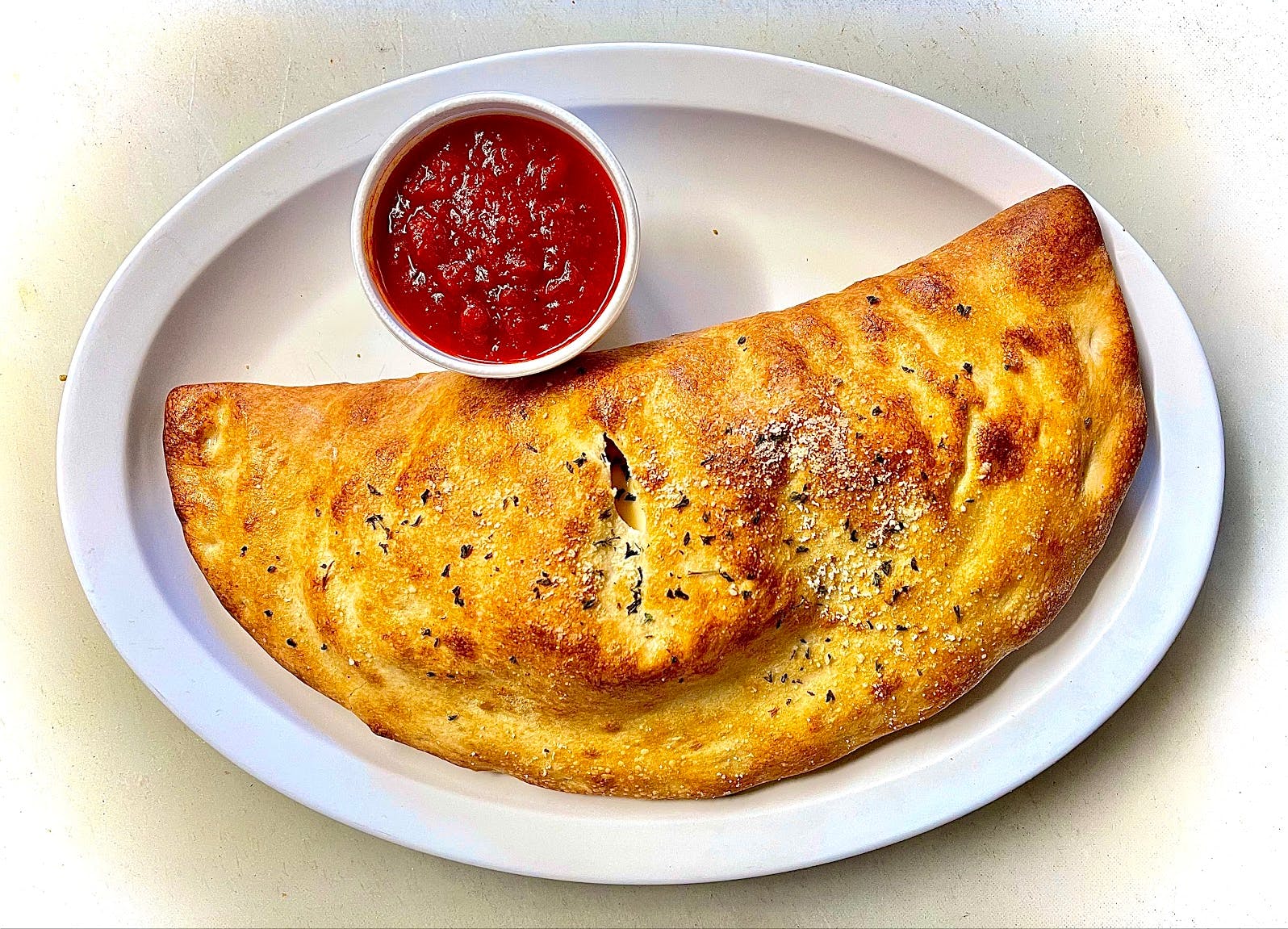 Order Cheese Calzone - Calzone food online from Sonny Restaurant & Pizzeria store, Englewood on bringmethat.com