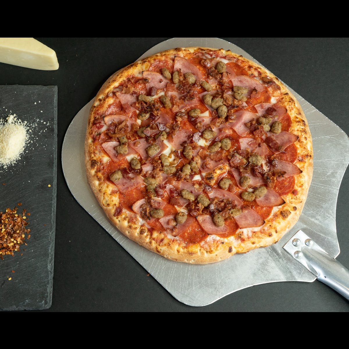 Order Massive Meat Pizza - Small 10'' food online from Tenney's Pizza store, Saratoga Springs on bringmethat.com