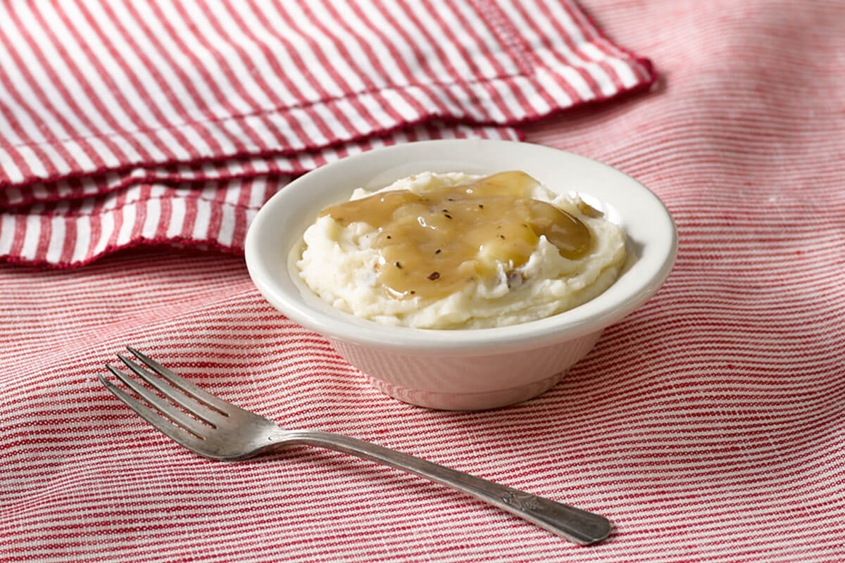 Order Mashed Potatoes with Brown Gravy food online from Cracker Barrel Old Country Store store, Arlington on bringmethat.com