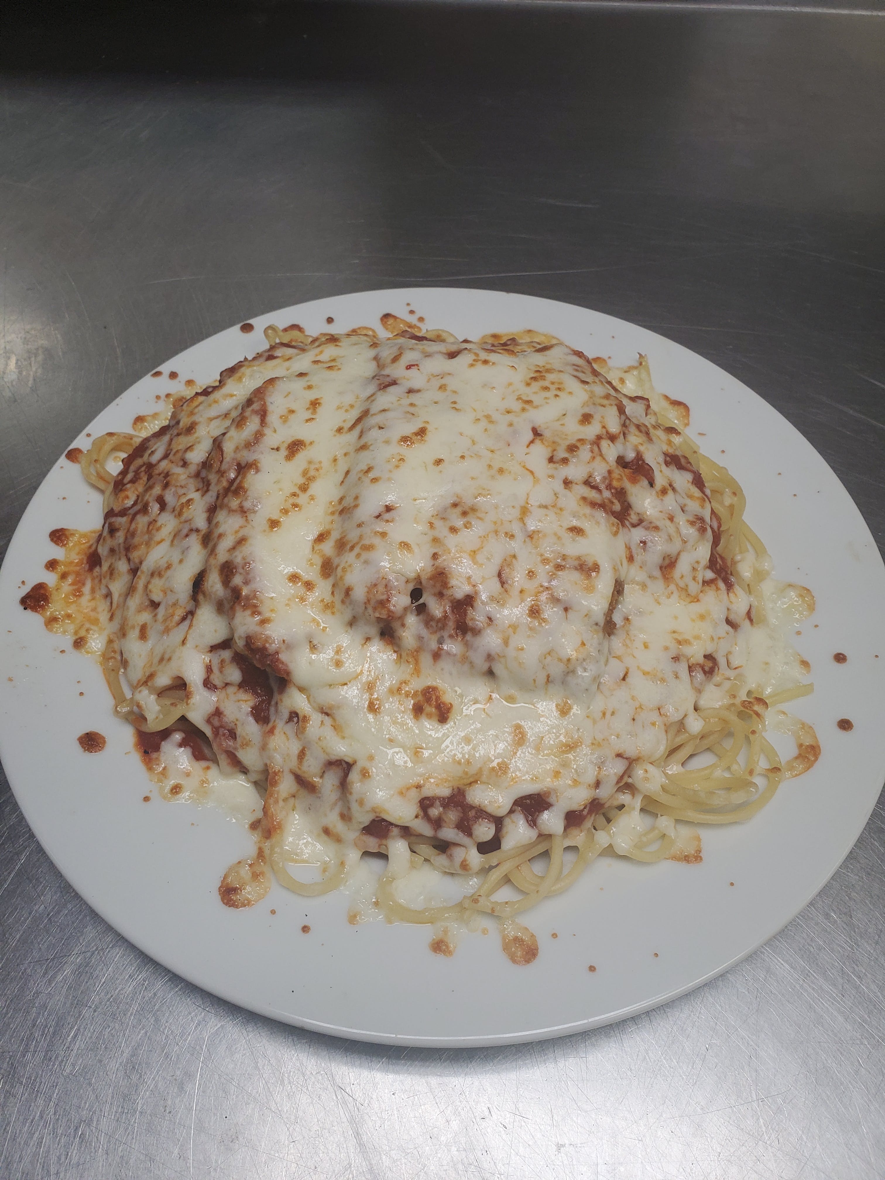 Order Chicken Parmigiana over Spaghetti - Pasta food online from Pizza Cucina store, Oswego on bringmethat.com