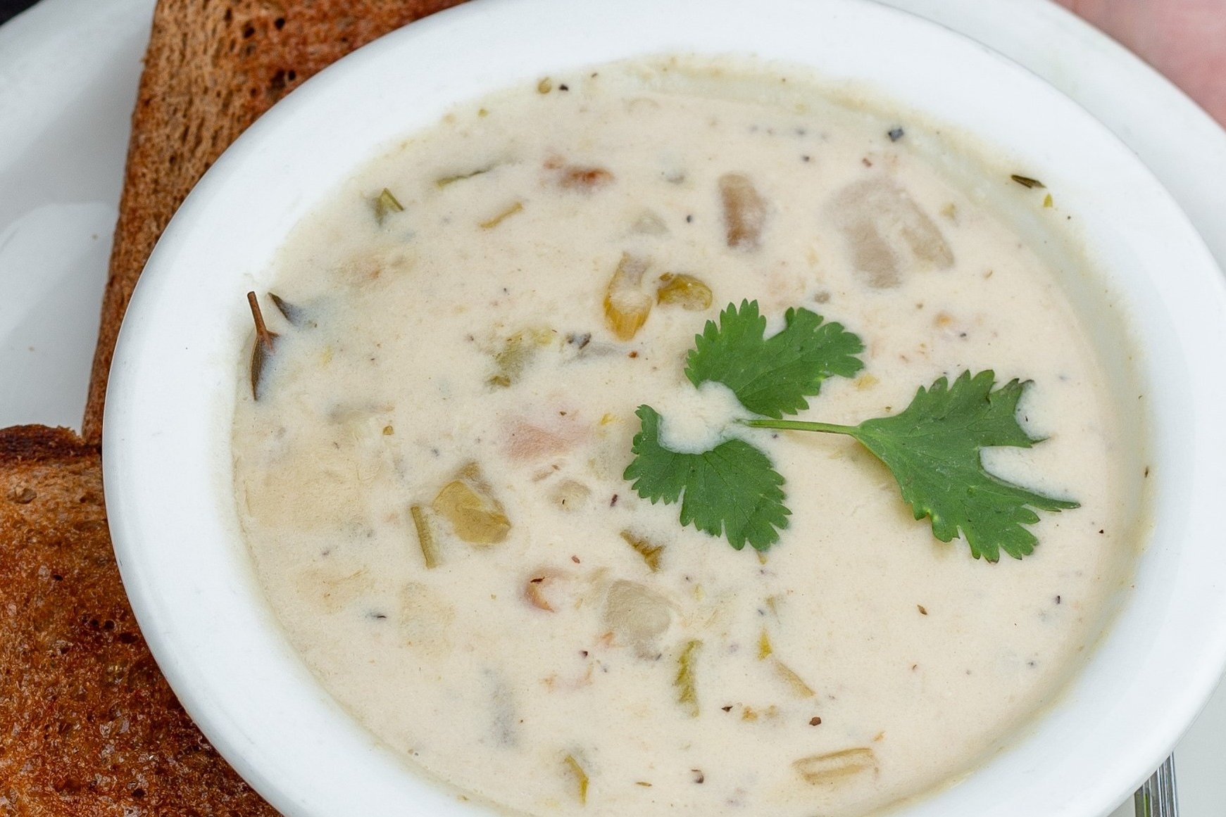 Order Clam Chowder Soup* food online from Swami Cafe store, San Diego on bringmethat.com
