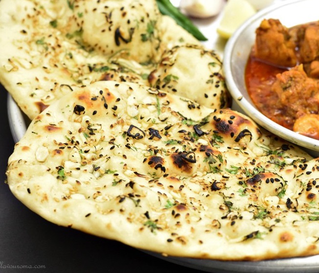 Order B2. Garlic Naan food online from India's Grill store, Tampa on bringmethat.com