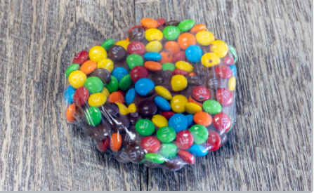 Order Dipped Pretzel -M and M food online from Rocky Mountain Chocolate Factory store, Terrell on bringmethat.com