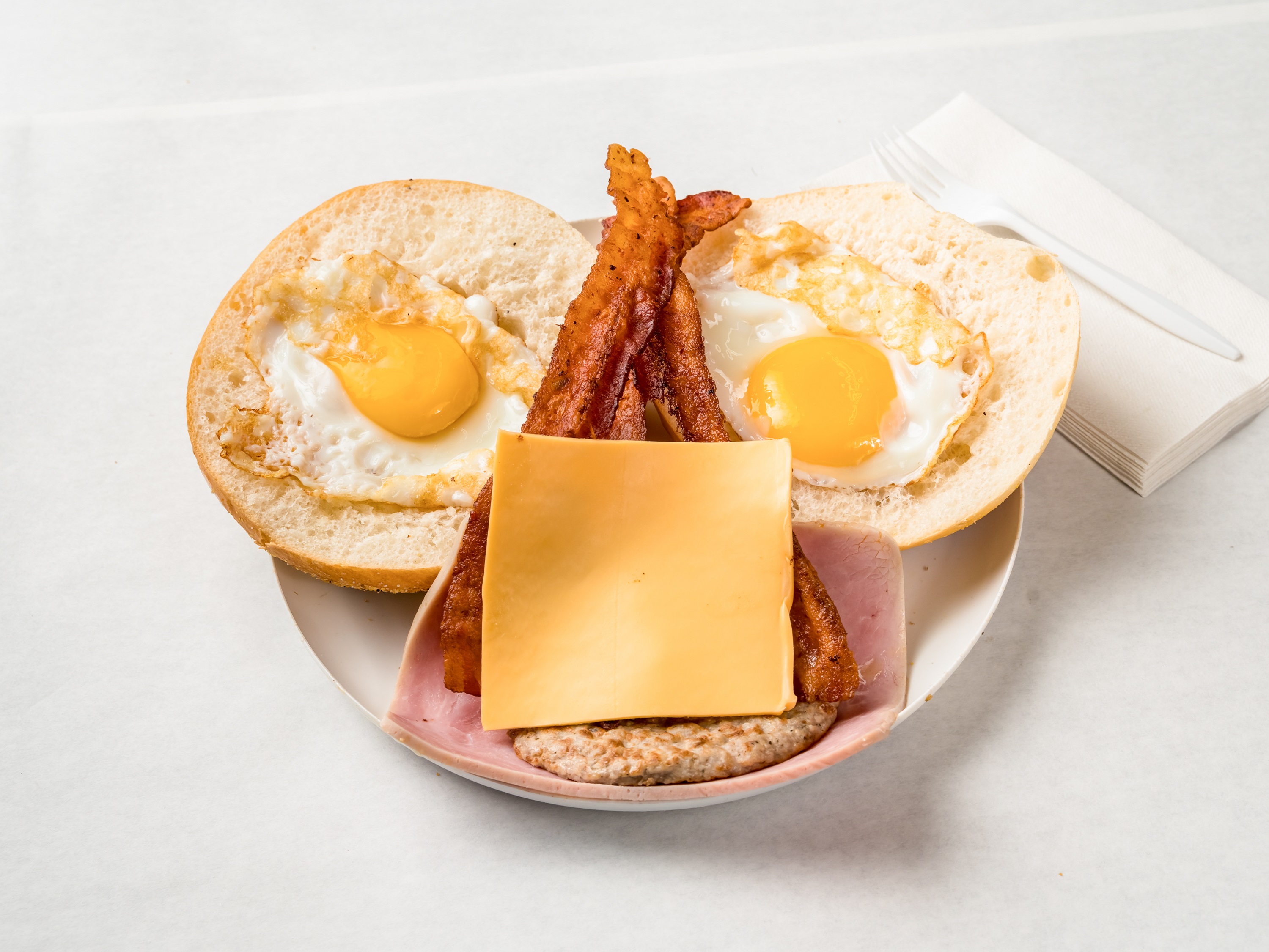Order 2 Eggs, Bacon and Ham Roll Sandwich food online from Polish Town Deli store, Riverhead on bringmethat.com