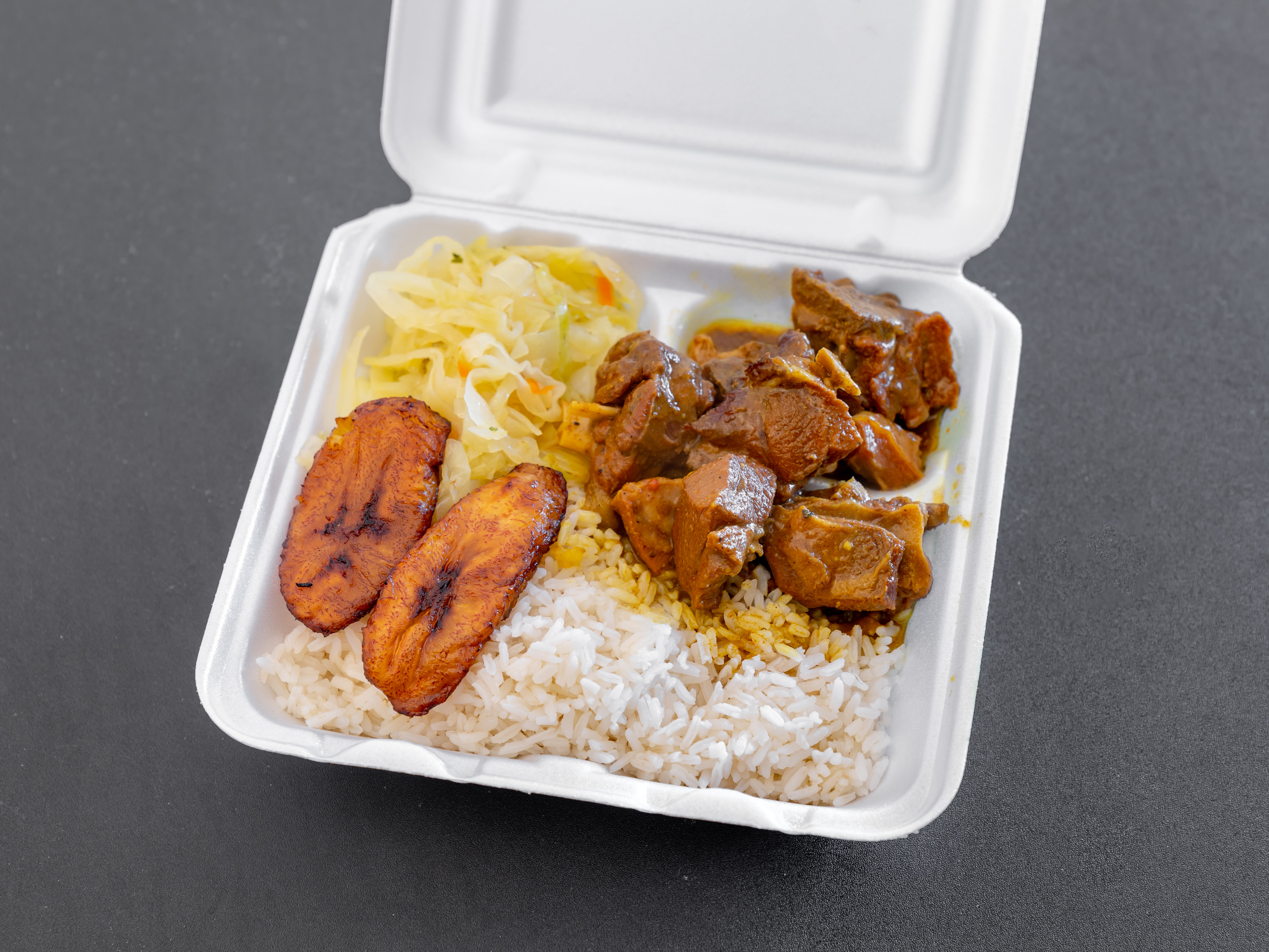 Order Curry Goat Dinner food online from Tip Top Willows store, Jonesboro on bringmethat.com