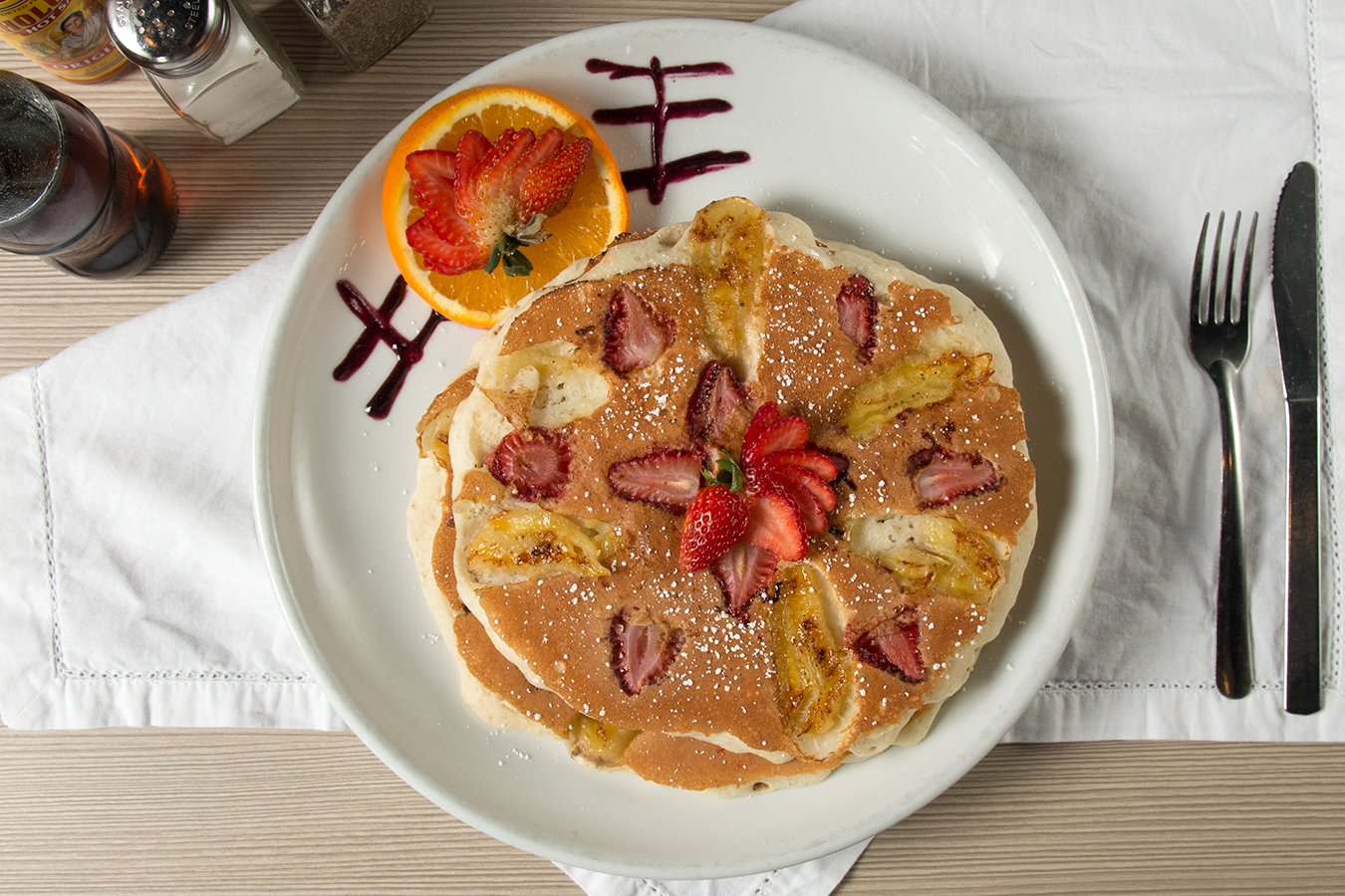 Order Strawberry Banana Pancakes* food online from Swami Cafe store, San Diego on bringmethat.com