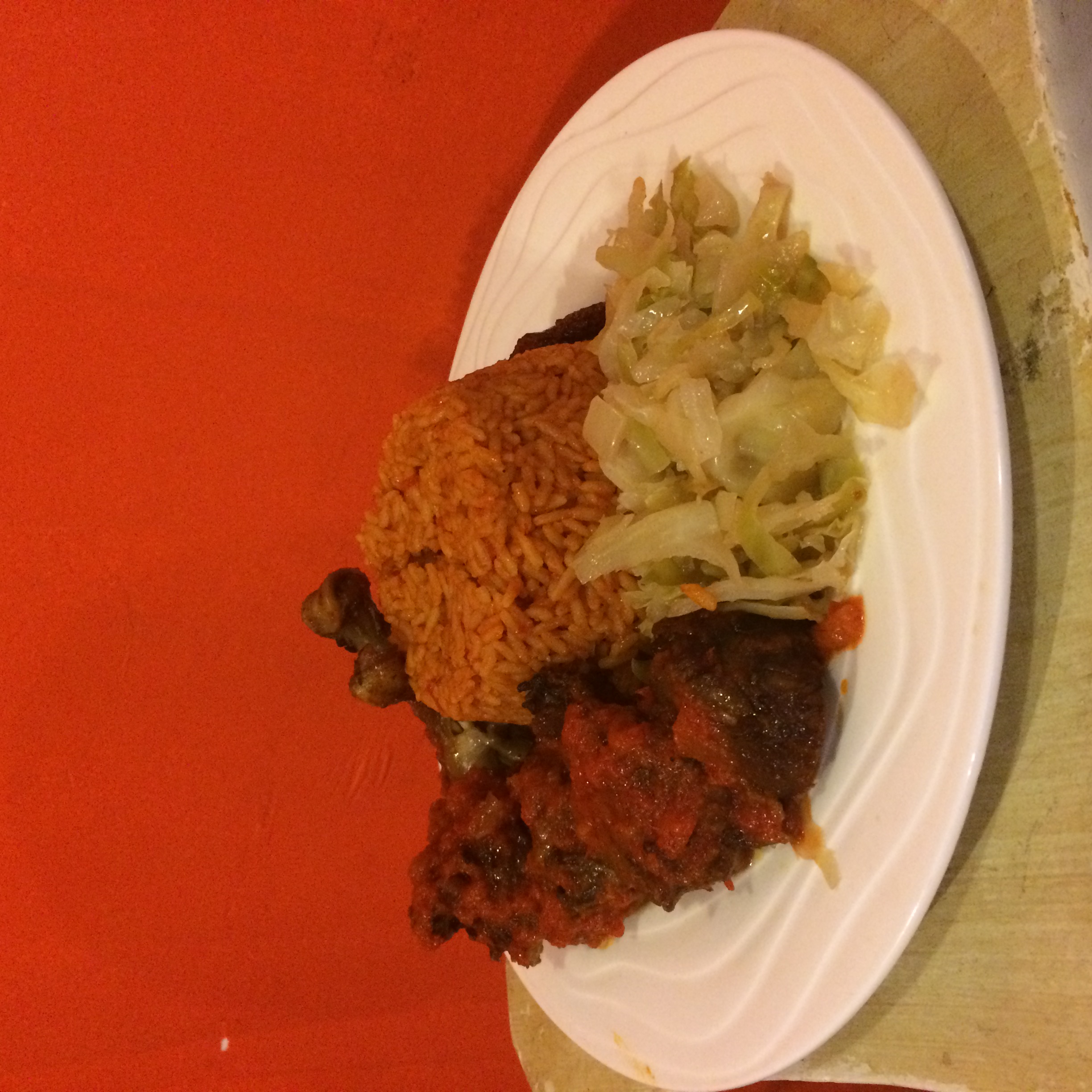 Order Jollof Rice with Cabbage & Stewed Chicken food online from Africarib Grill store, Newark on bringmethat.com