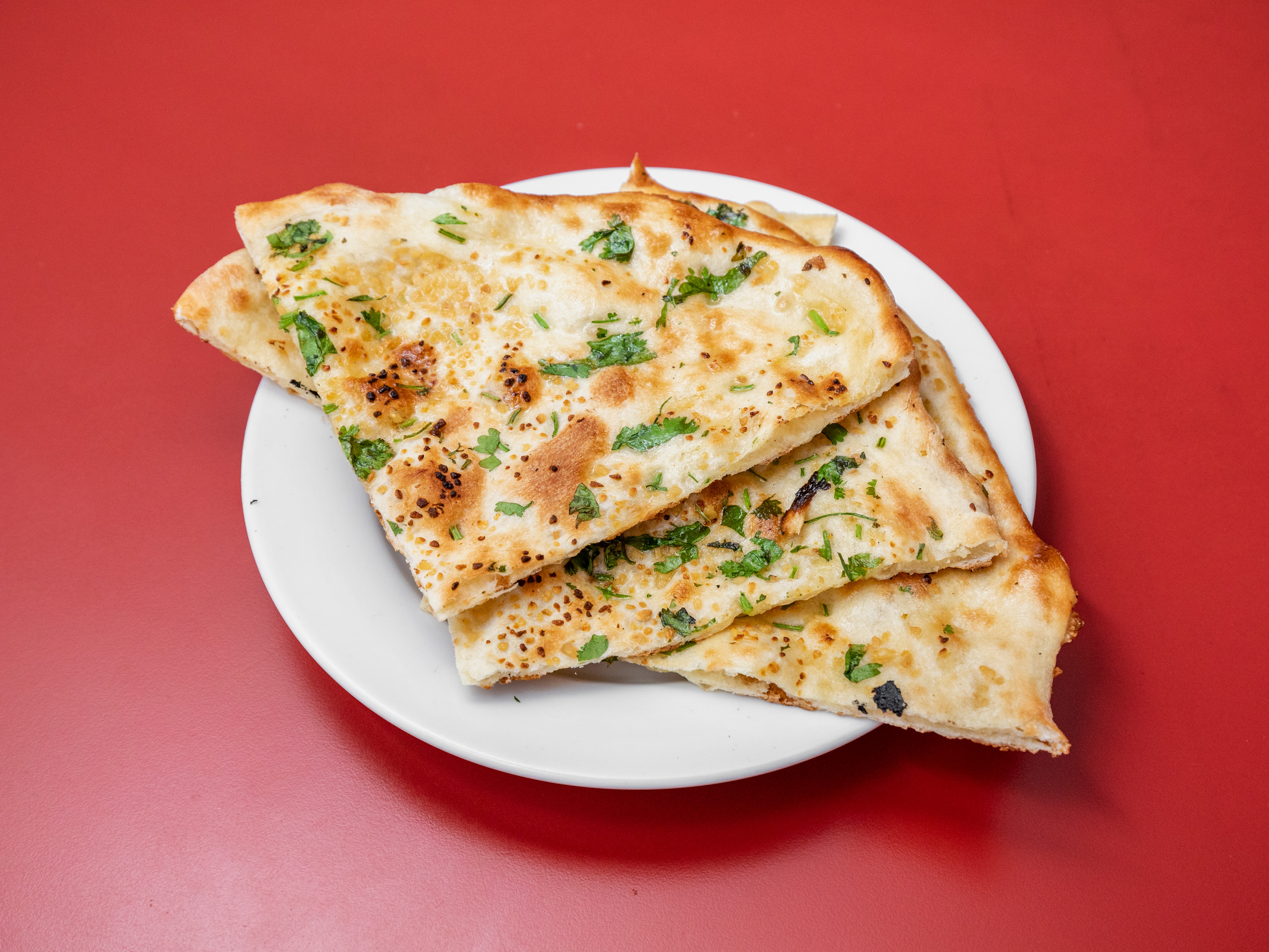 Order 74. Garlic Naan food online from India House store, Portland on bringmethat.com