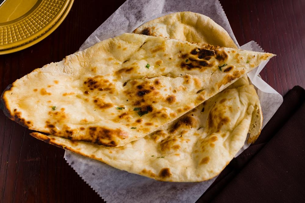 Order Naan food online from Dhaba indian cuisine store, New York on bringmethat.com