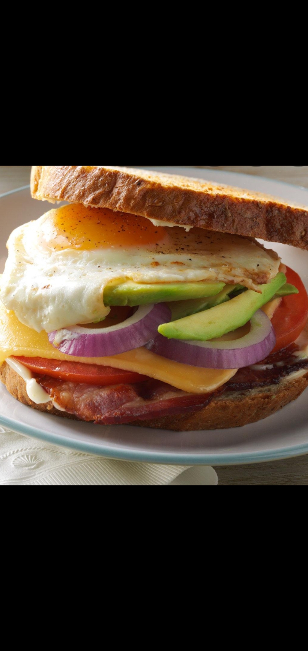 Order Bacon Eggs Cheese Avocado Tomatoes & Red Onions Better Breakfast Sandwich  food online from American Gourmet Foods Deli store, New York on bringmethat.com