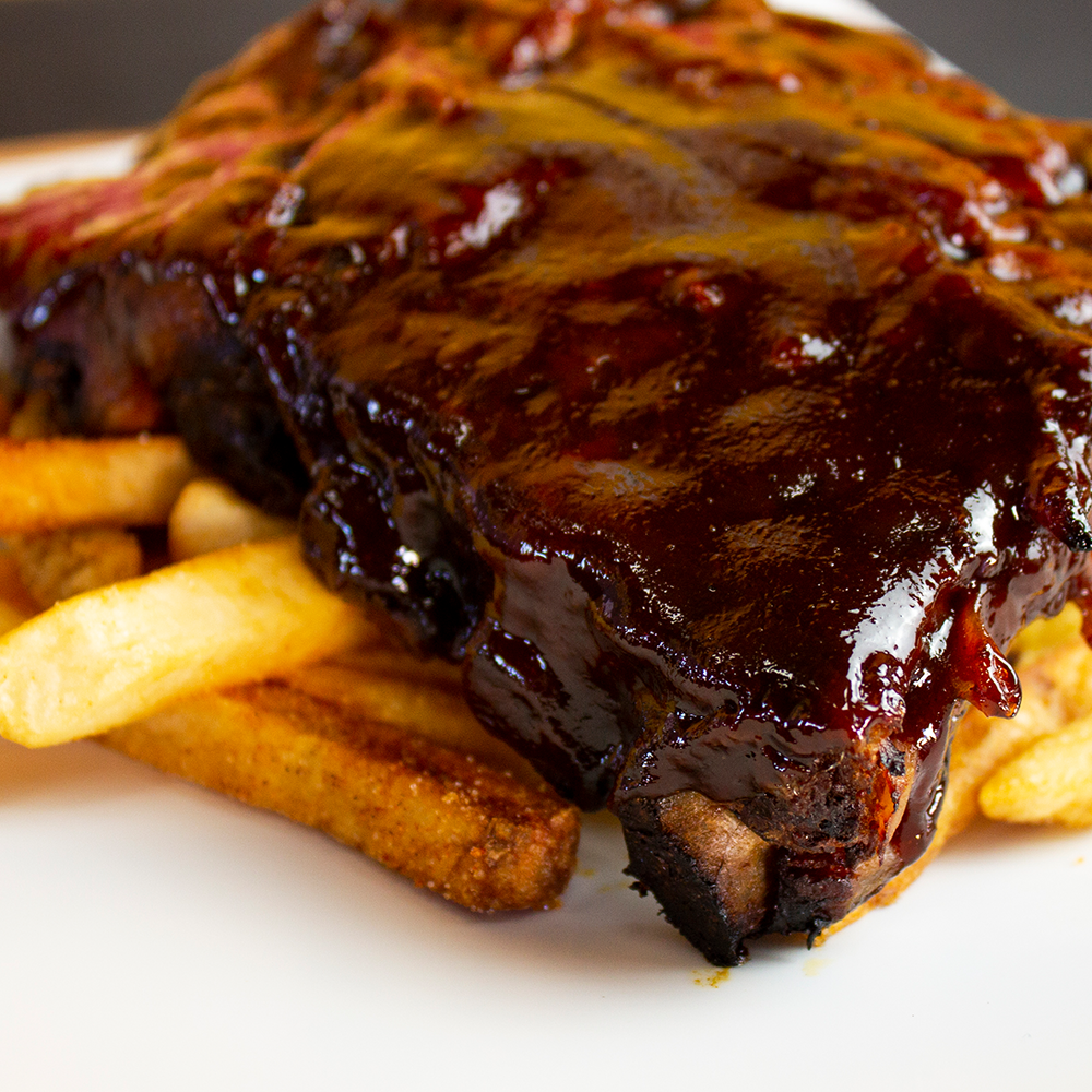 Order BBQ Ribs (Pork) food online from Wings Empire store, San Diego on bringmethat.com
