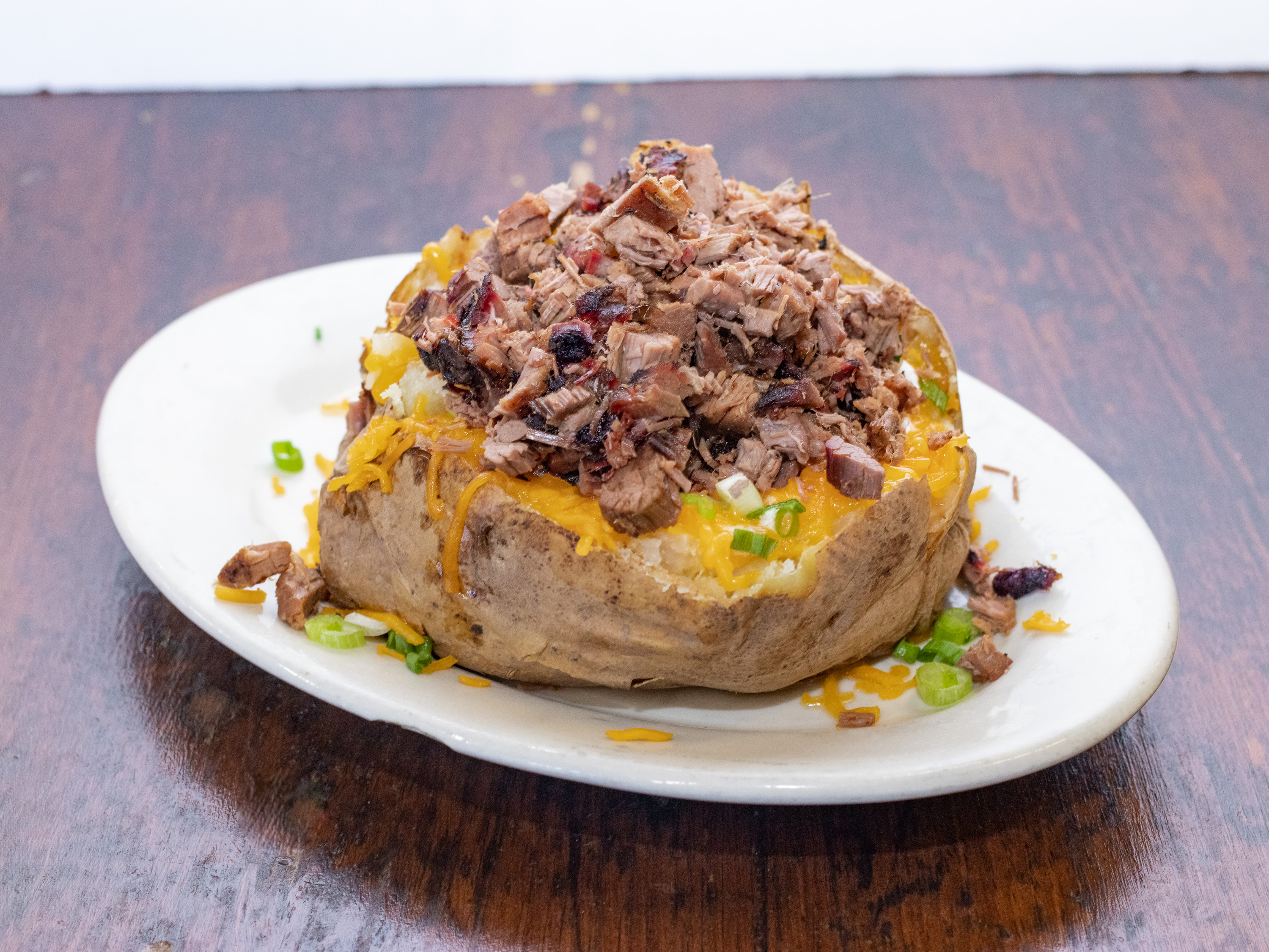 Order Loaded Baked Potatoes food online from Lyndon's Pit Bar-B-Q store, Houston on bringmethat.com